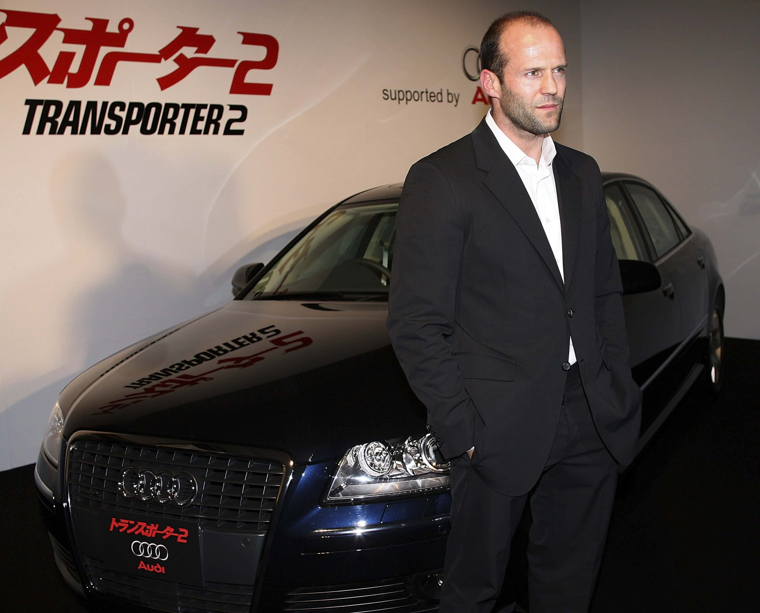 Actor Jason Statham poses in front of a car during a press conference promoting 