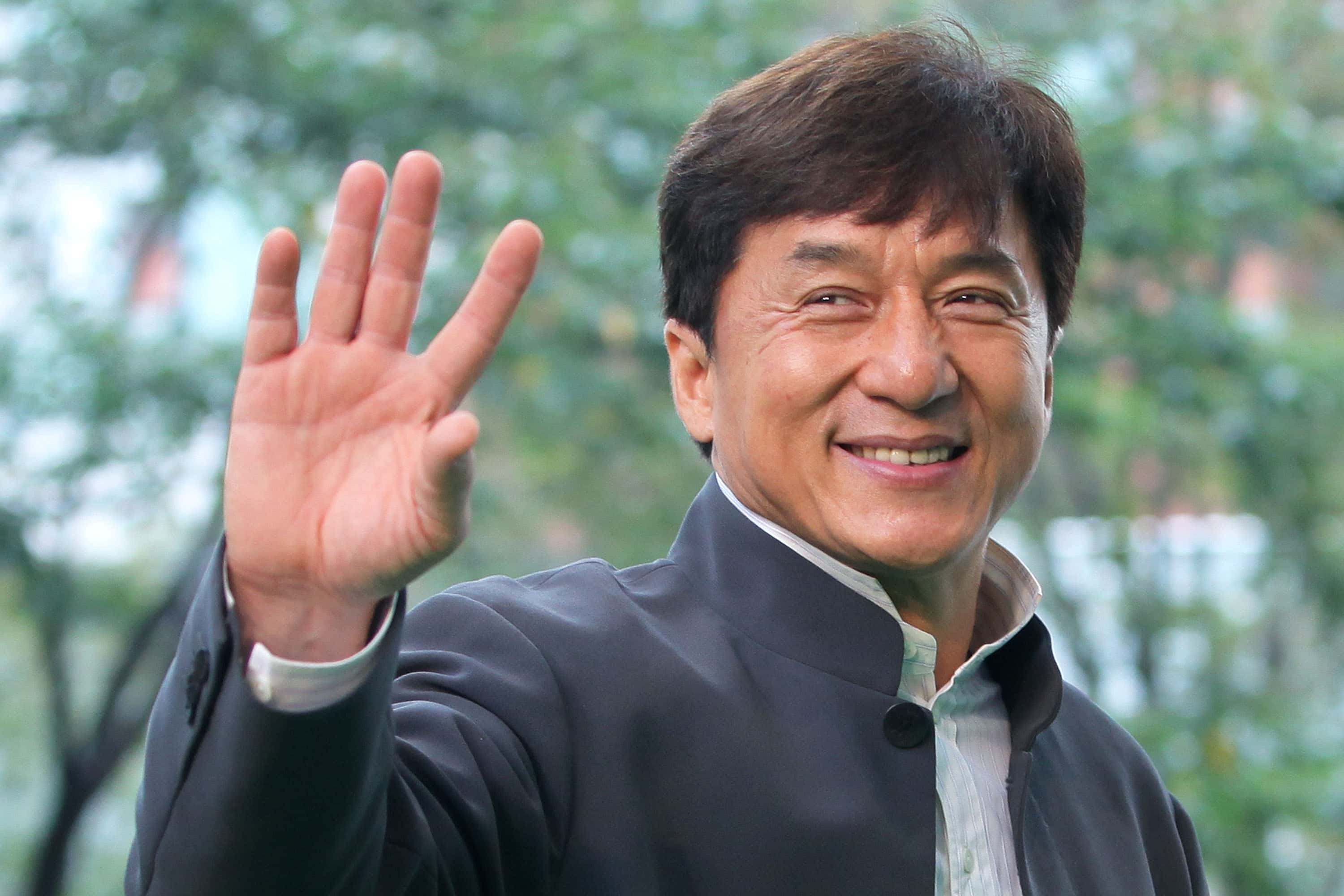 Director and actor Jackie Chan waves as he attends the 24th Tokyo International Film Festival (TIFF) Opening Ceremony