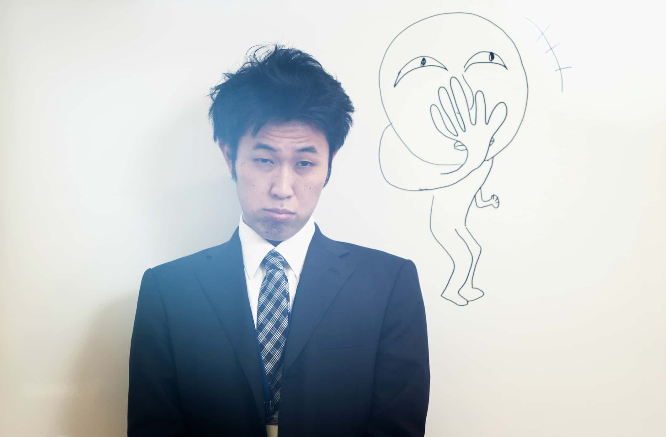 Japanese business man in front of a white board.