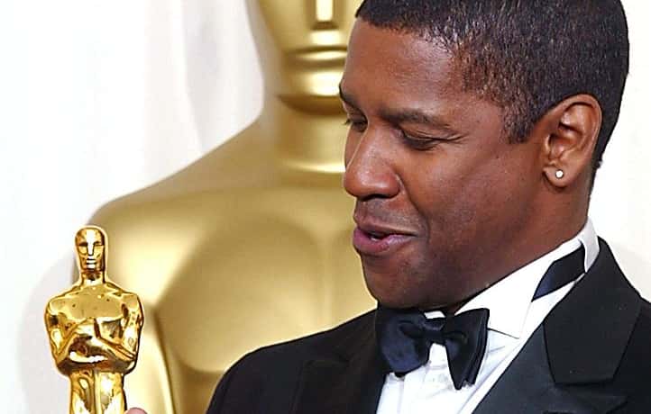 US actor Denzel Washington holds his Oscar