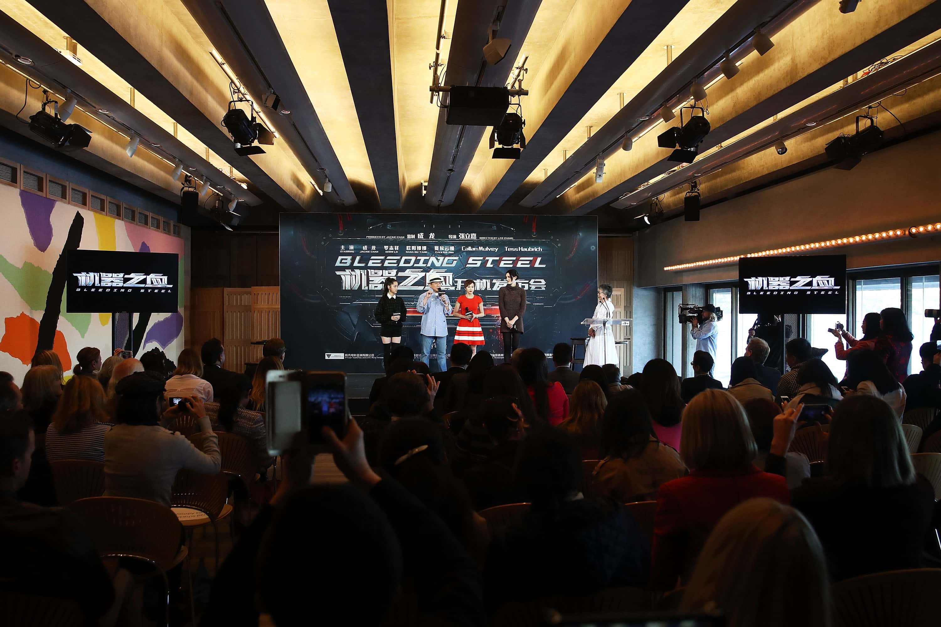 Nana Ouyang, Jackie Chan, Erica Xia-hou and Tess Haubrich speak on stage during a press conference and photocall for Bleeding Steel