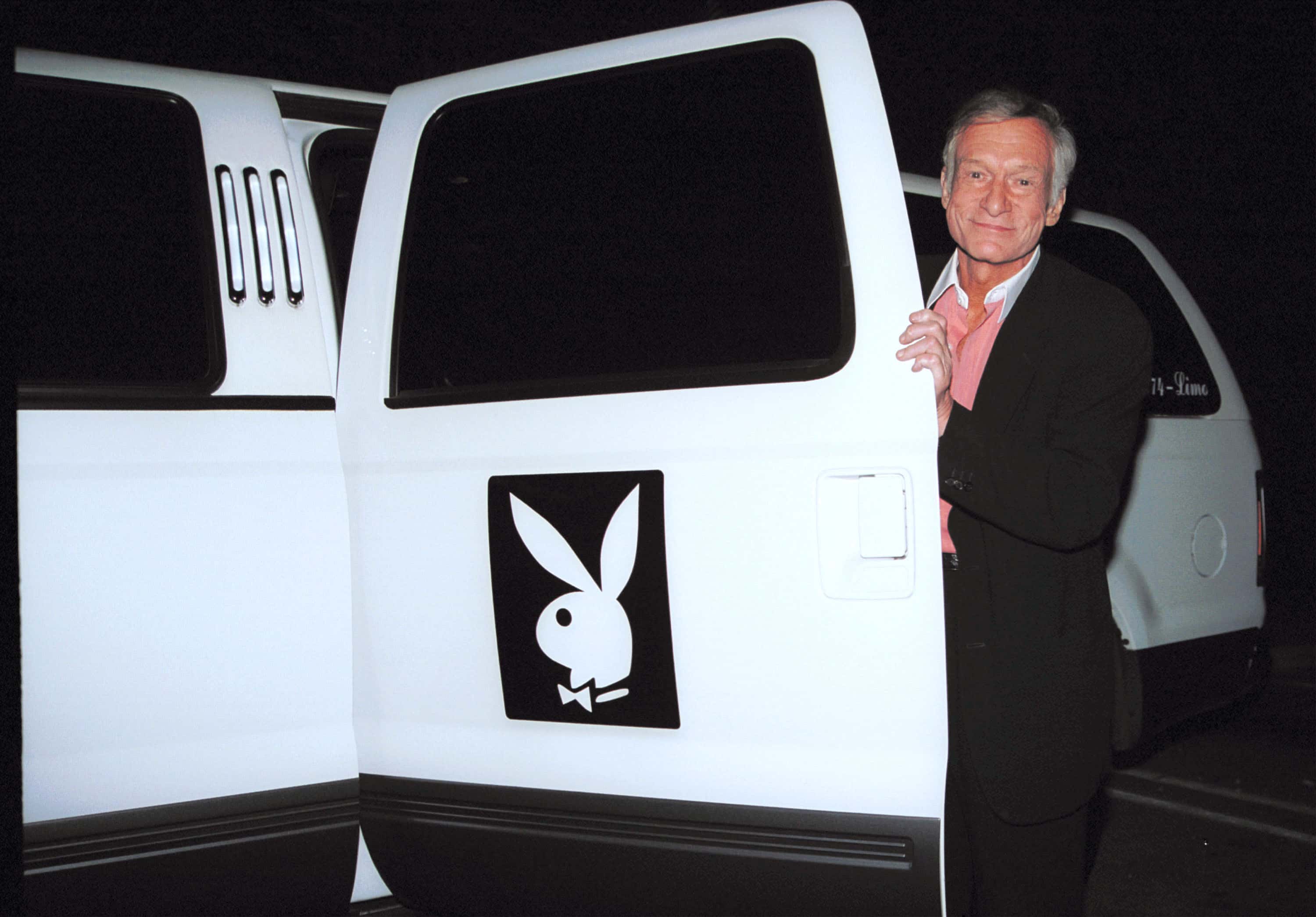 Playboy founder Hugh Hefner shows off his limo
