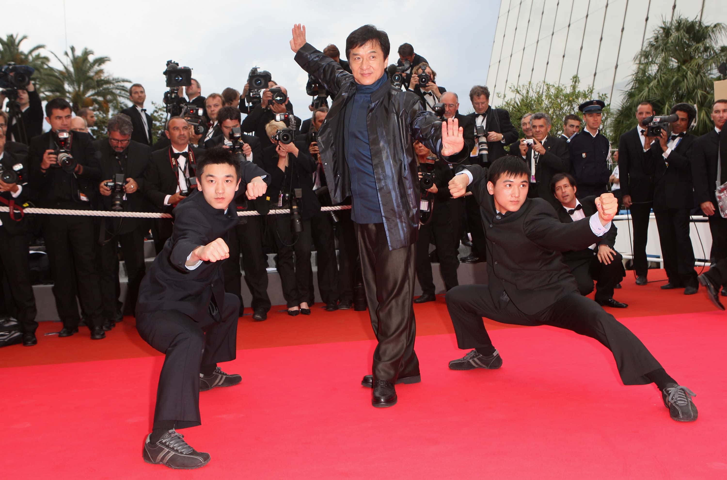 Actors Liu Fengchao, Jackie Chan and Wang Wenjie attend the 'Le Silence De Lorna' Premiere at the Palais des Festivals during the 61st International Cannes Film Festival