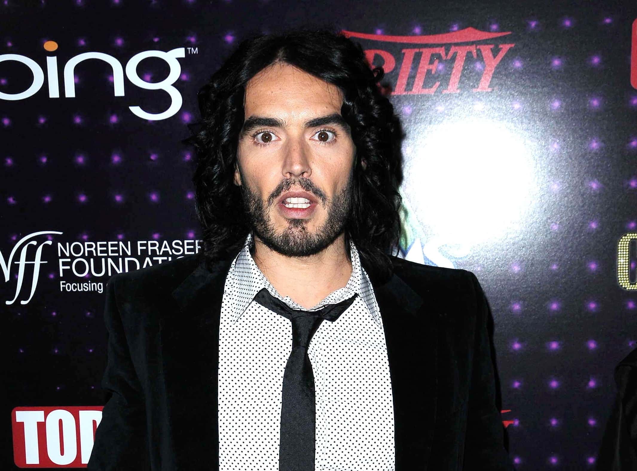 Russell Brand posing for a photo