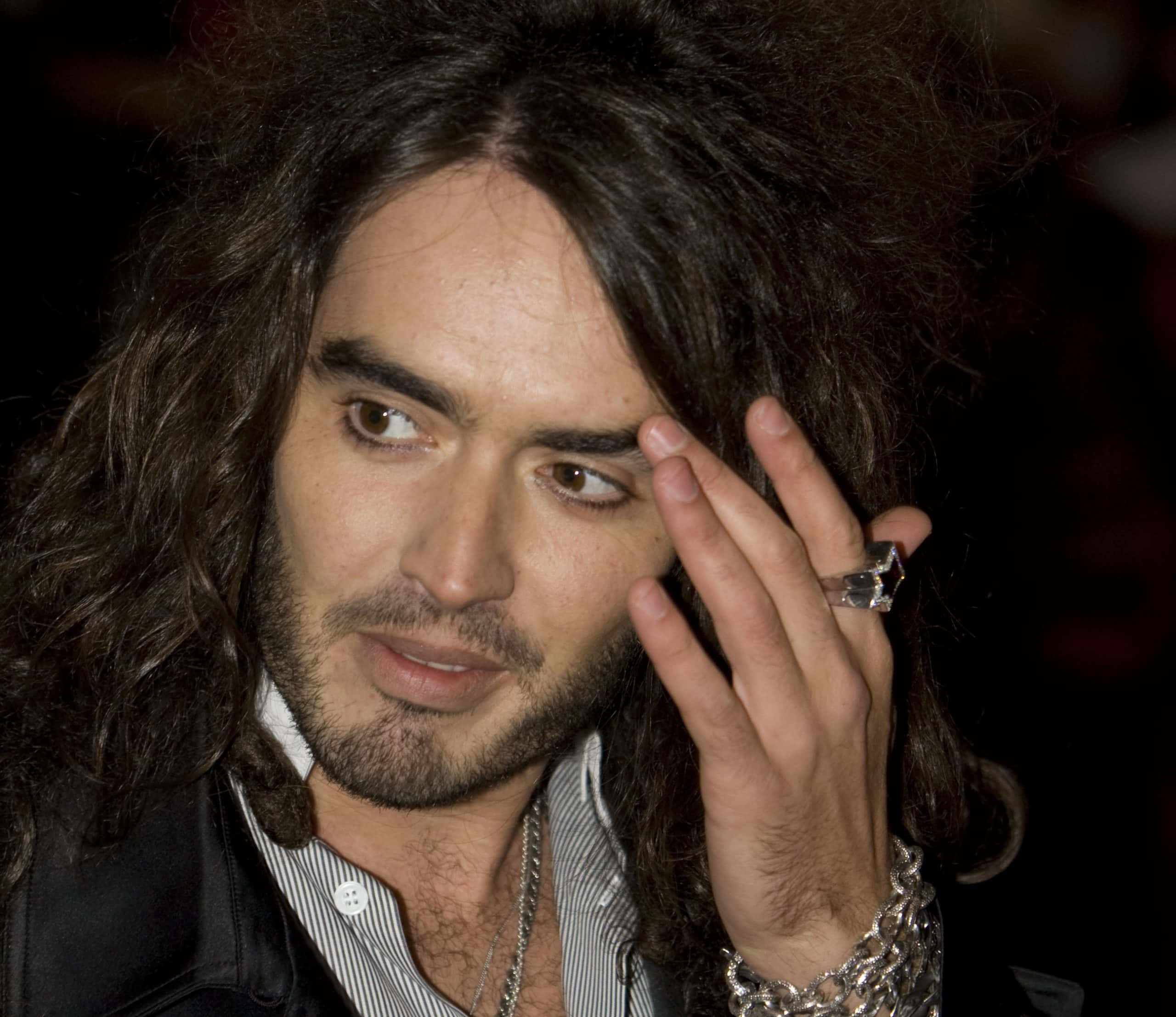 Russell Brand posing for a photo