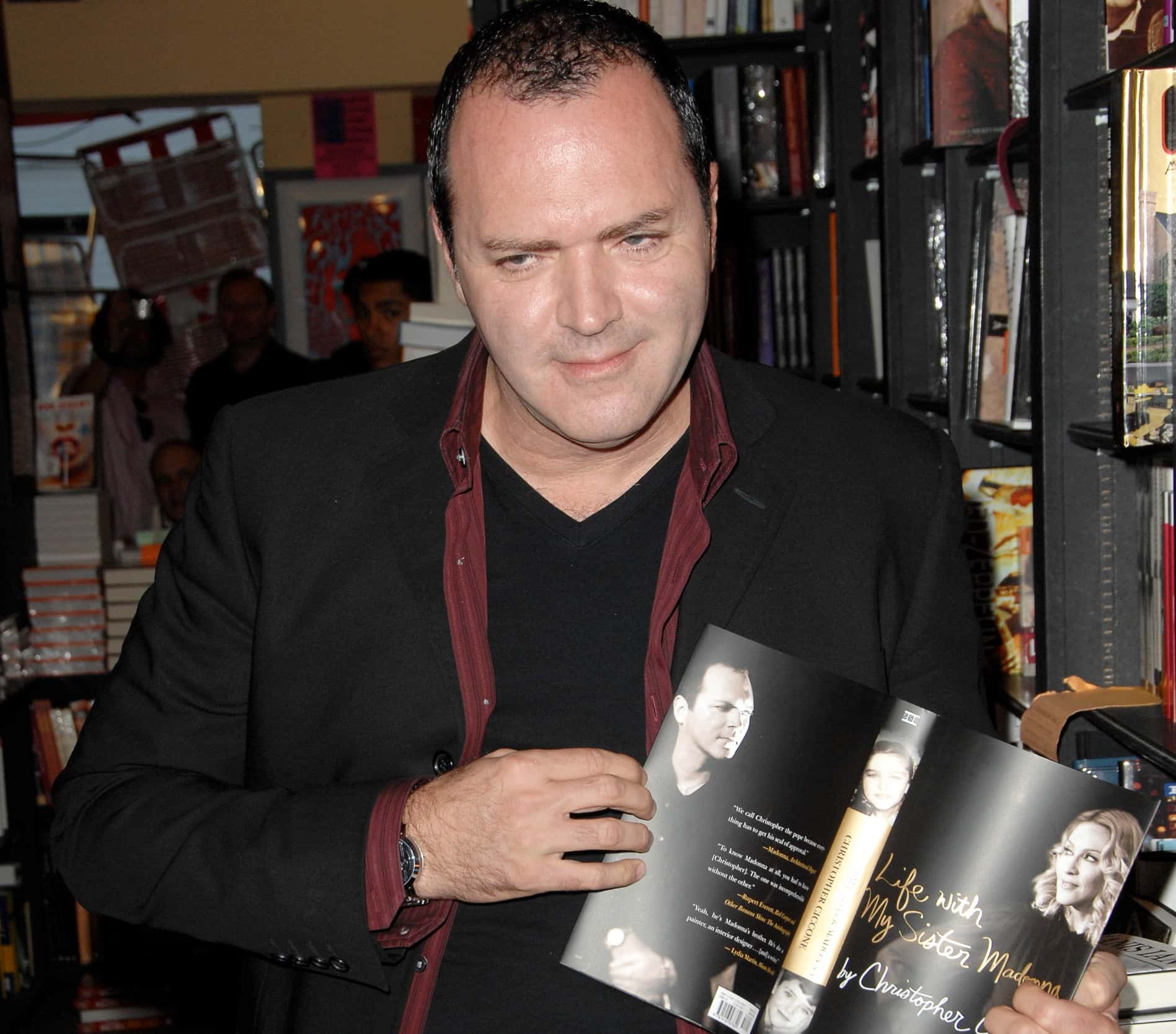 Christopher Ciccone holding a magazine