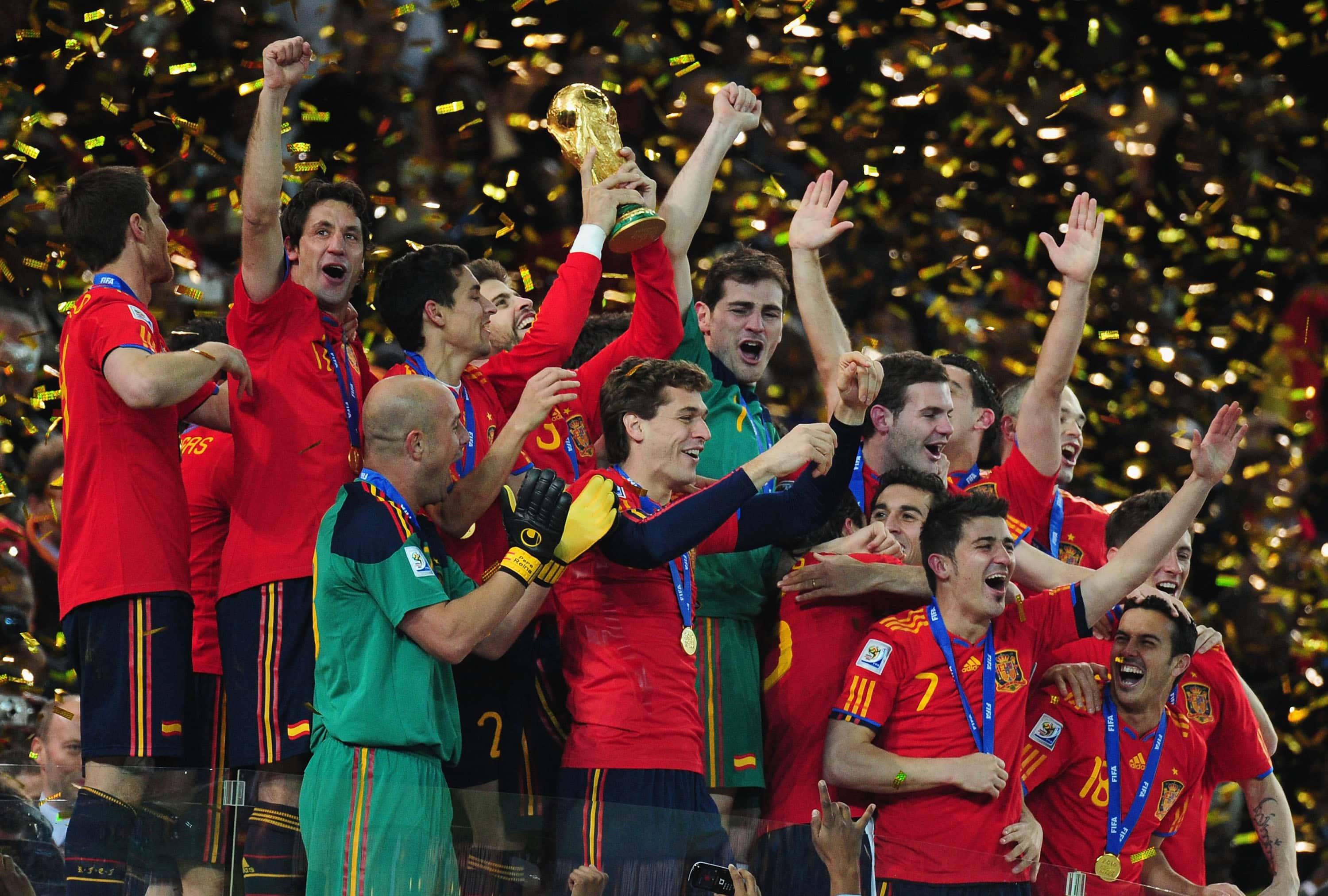  Gerard Pique of Spain (C), and the Spain team celebrate victory with the World Cup trophy following the 2010 FIFA 