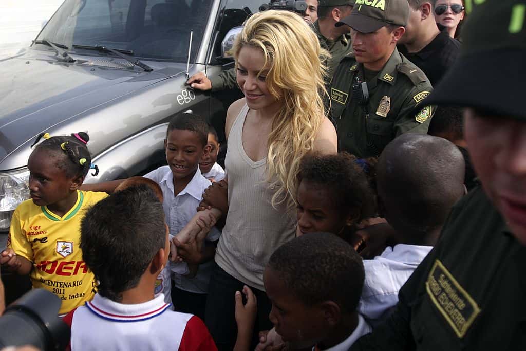 Colombian pop star Shakira greets children