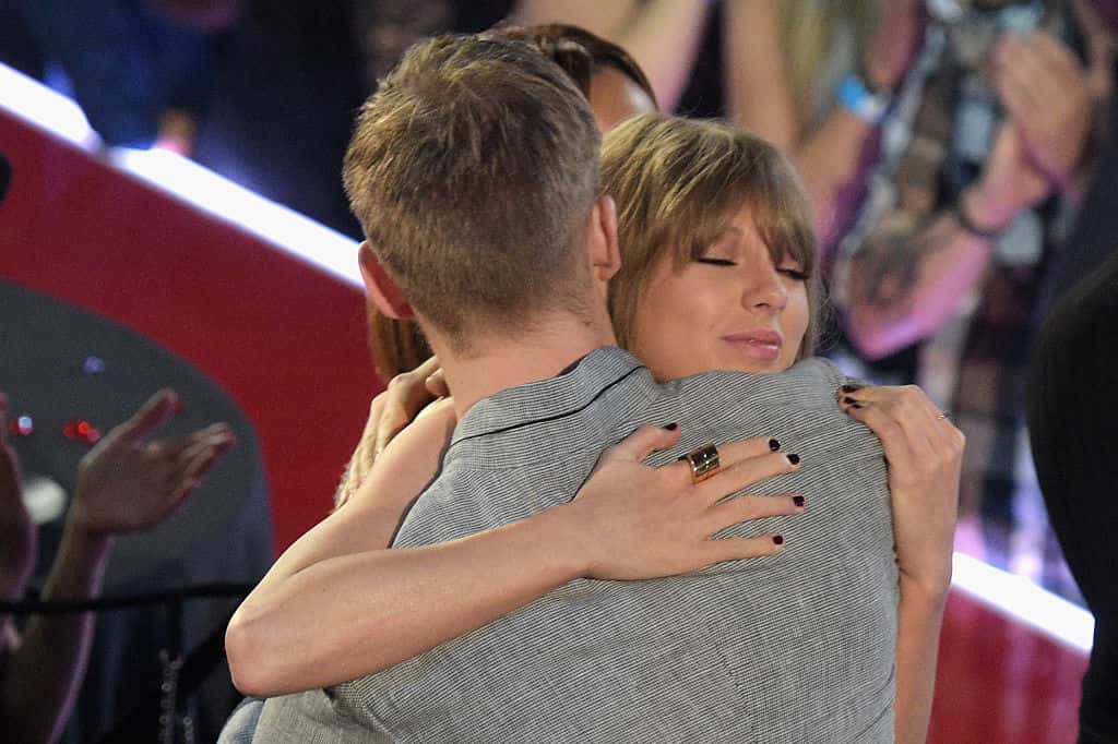 Recording artist Taylor Swift hugs Calvin Harris