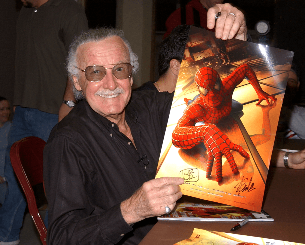 Spider-Man creator Stan Lee holds a Spider-Man poster