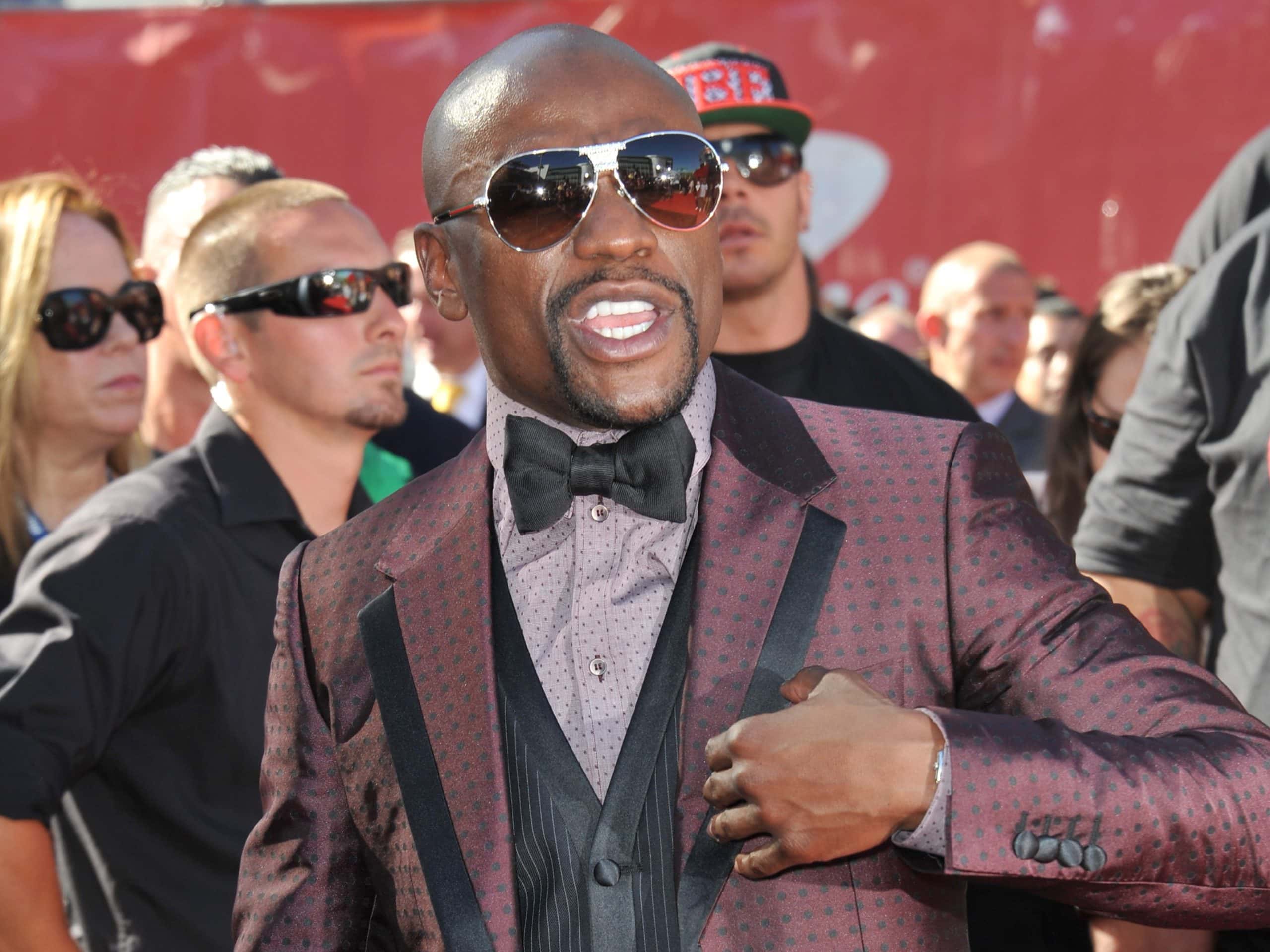 Floyd Mayweather Jr. wearing sunglasses and suit