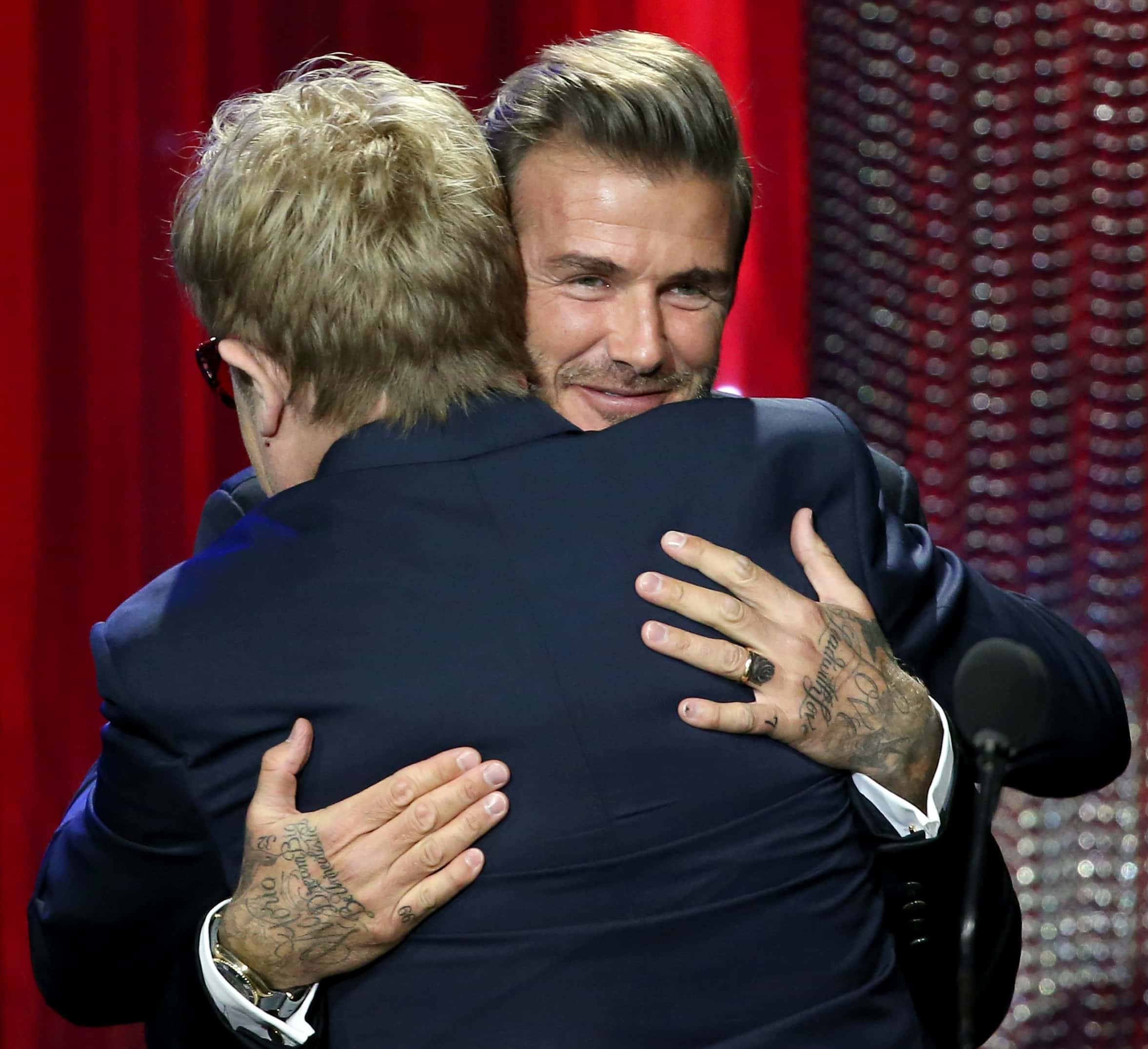 Recording artist Elton John (L) and UNICEF GWA Honoree David Beckham speaks onstage during the Sixth Biennial UNICEF Ball