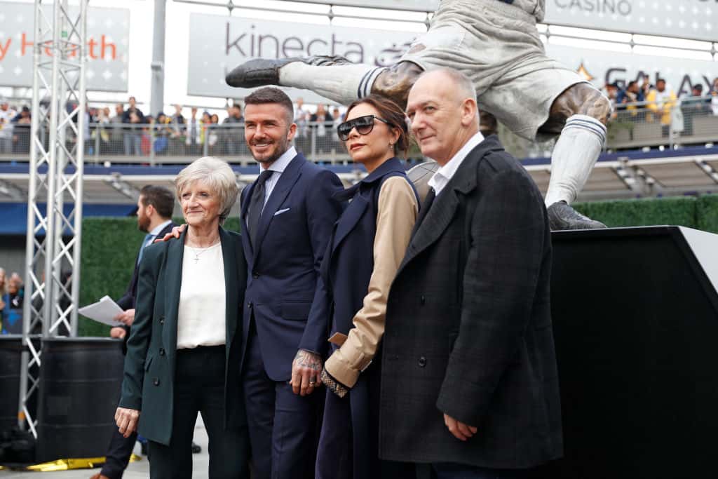 David Beckham poses with his wife Victoria Beckham and parents