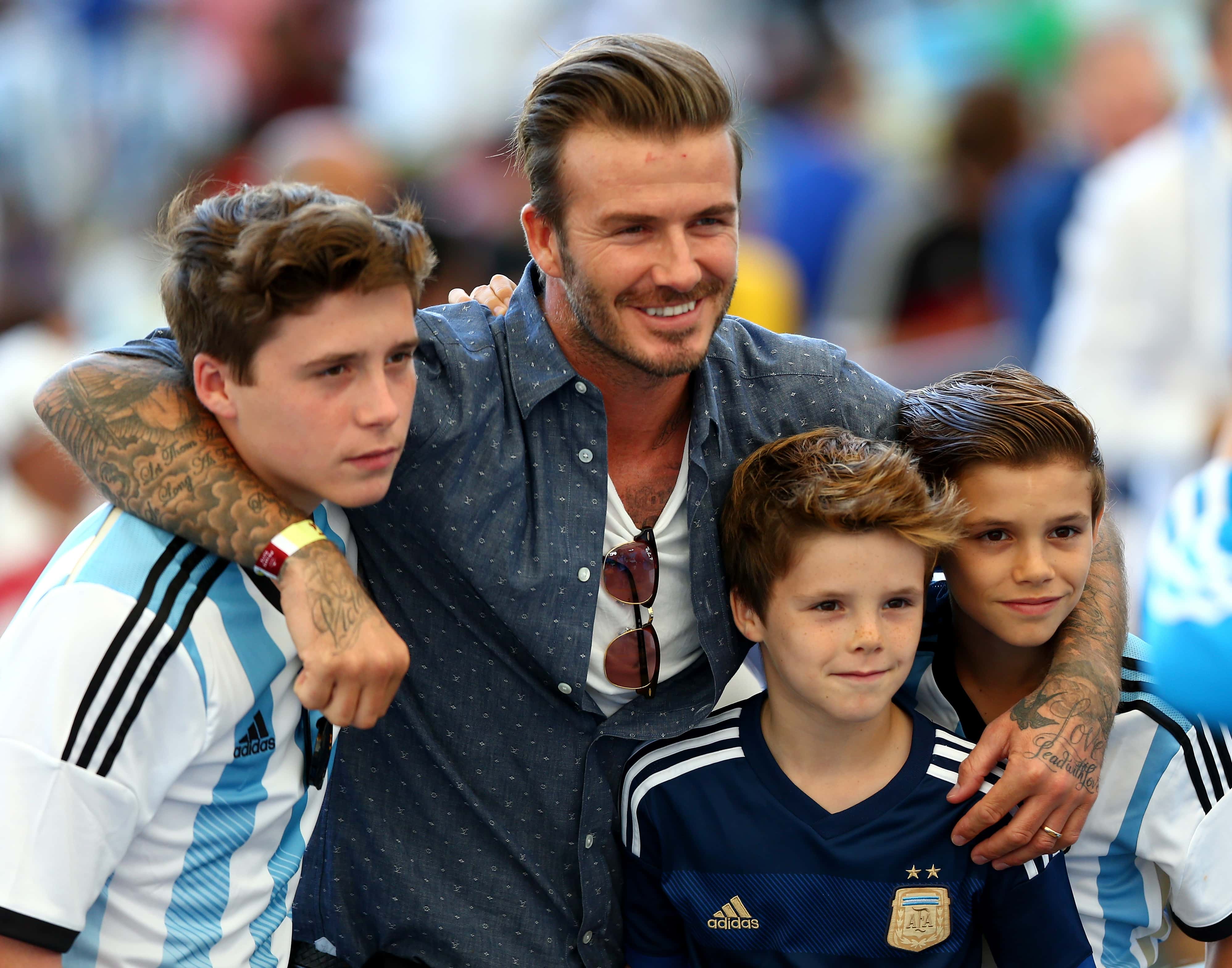David Beckham and sons Brooklyn Beckham (L), Cruz Beckham (2nd R) and Romeo Beckham (R) at the 2014 FIFA World Cup 