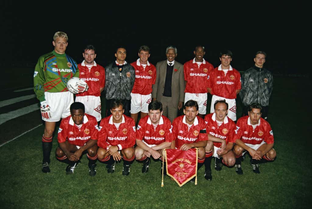 The Manchester United team line-up together for a group photograph with Nelson Mandela