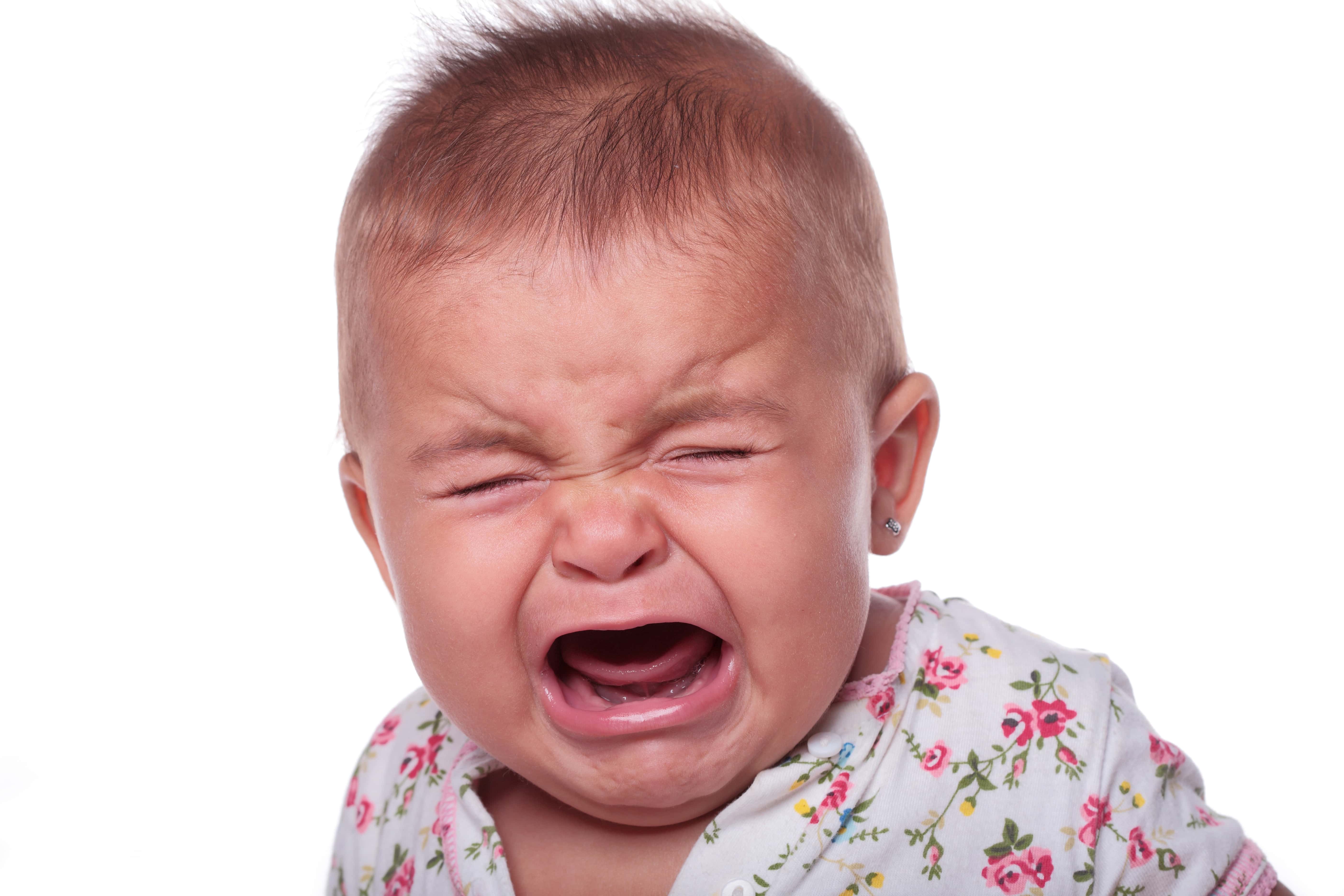 Portrait Of Crying Baby Against White Background.