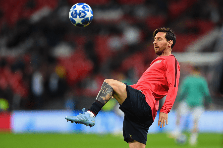 A tattooed Barcelona forward Lionel Messi warming up