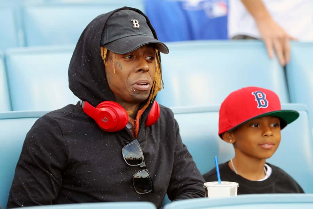 Lil Wayne is seen in the stands with his son prior to Game 5