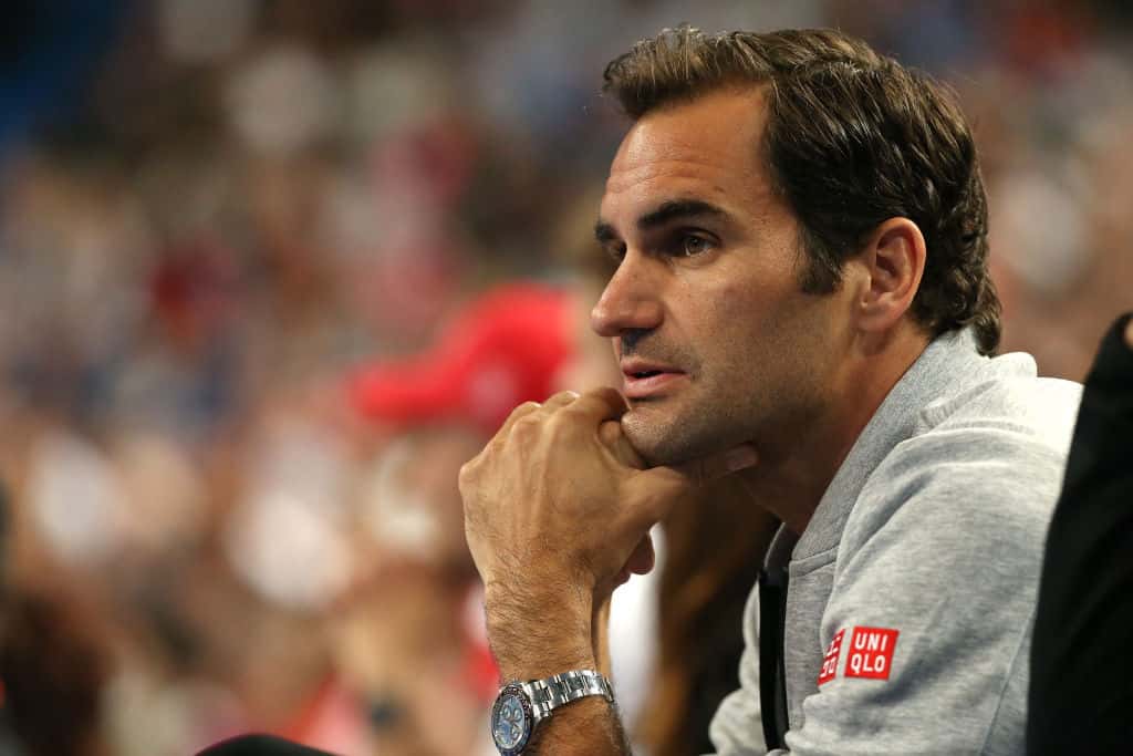 Roger Federer of Switzerland watches the women's singles match between Belinda Bencic of Switzerland and Maria Sakkari of Greece