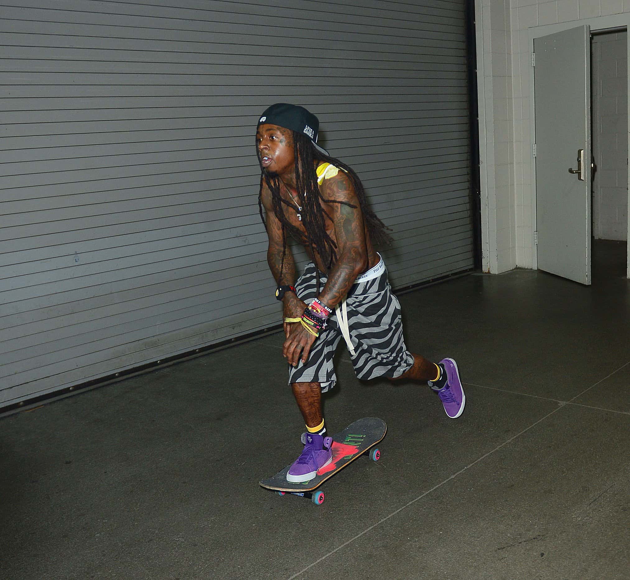Lil Wayne skateboards backstage