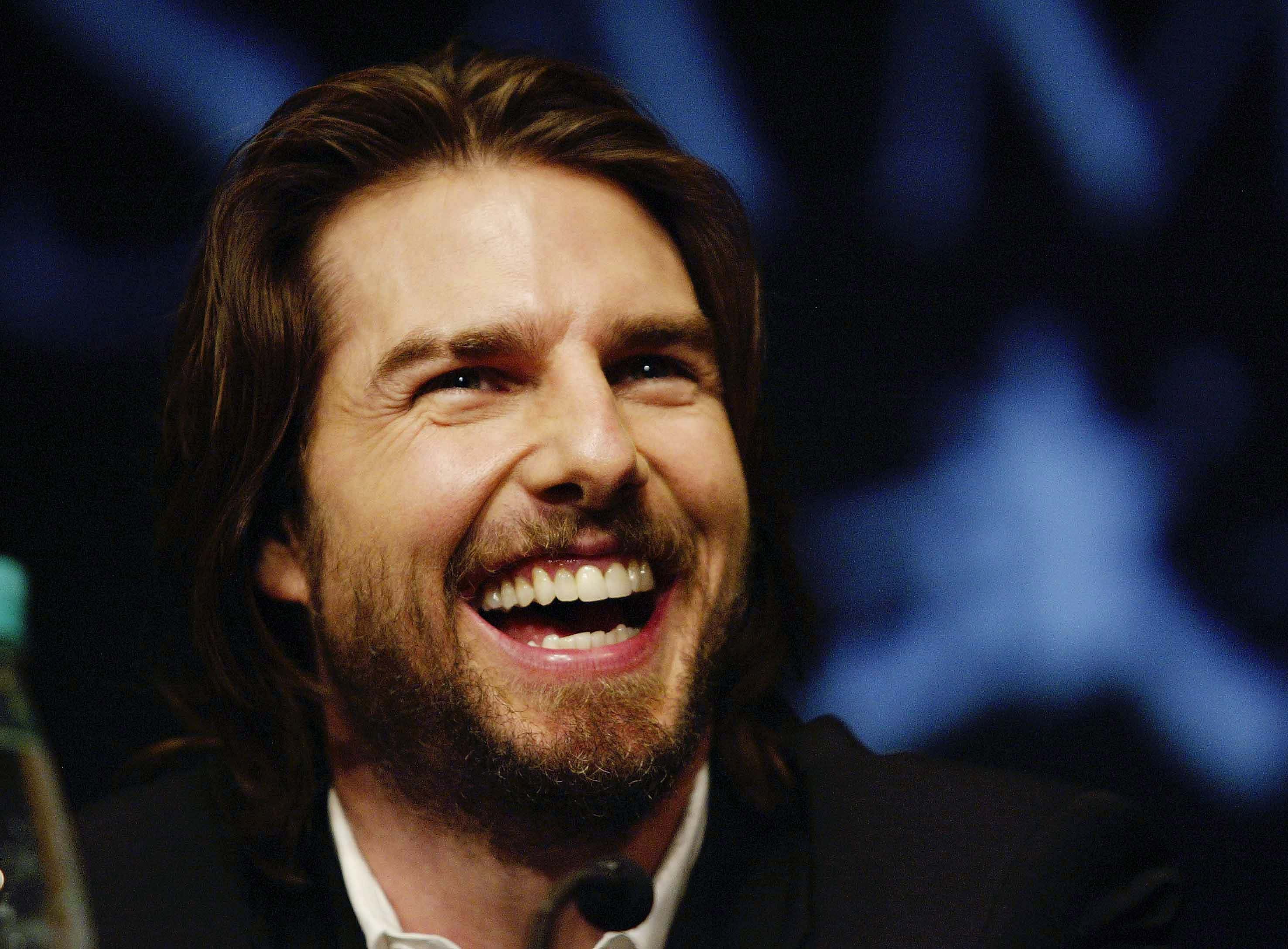 Actor Tom Cruise laughs as he speaks to the media