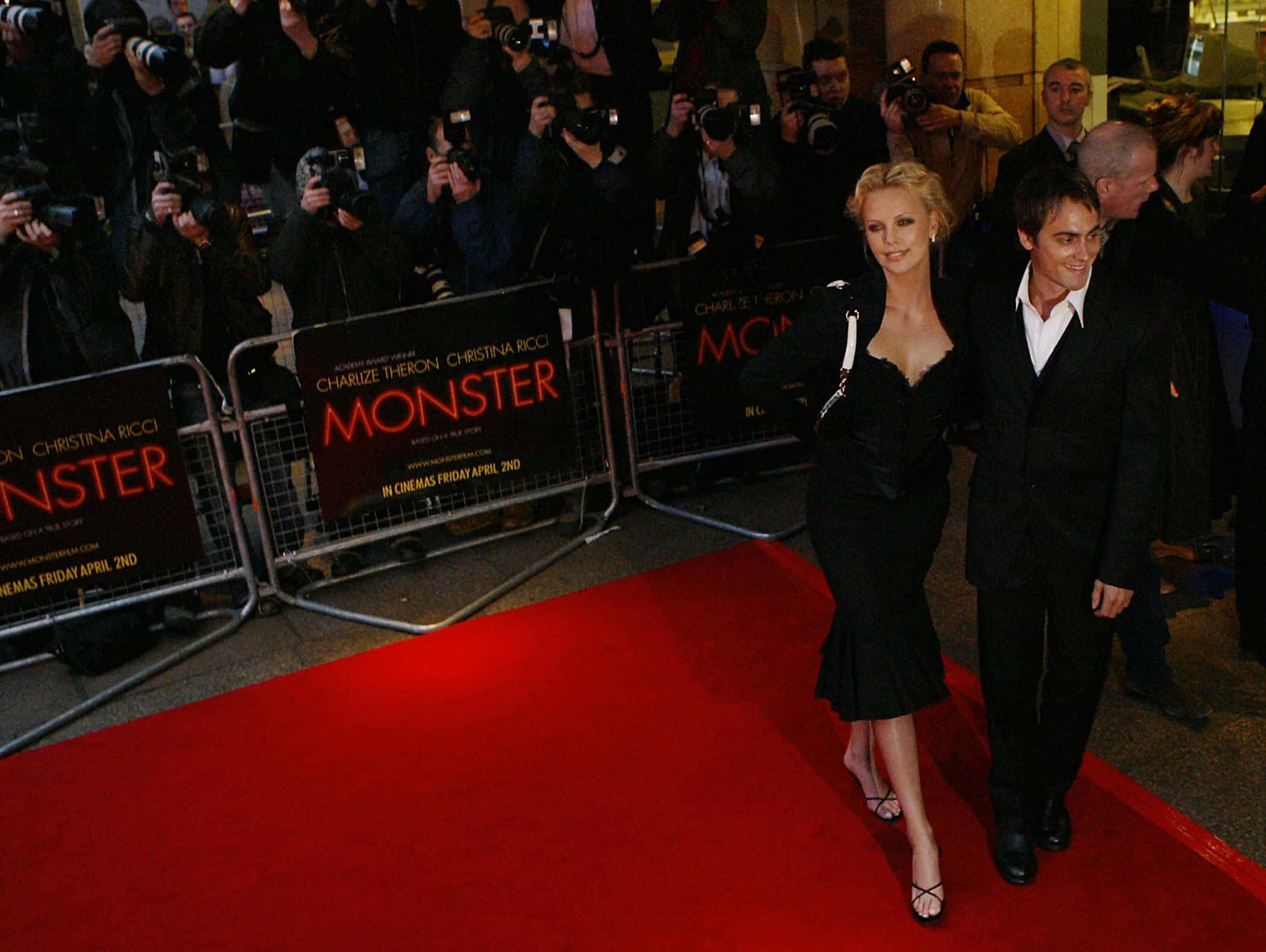  Charlize Theron (L) arrives at the Warner Village Theatre in London - 2004