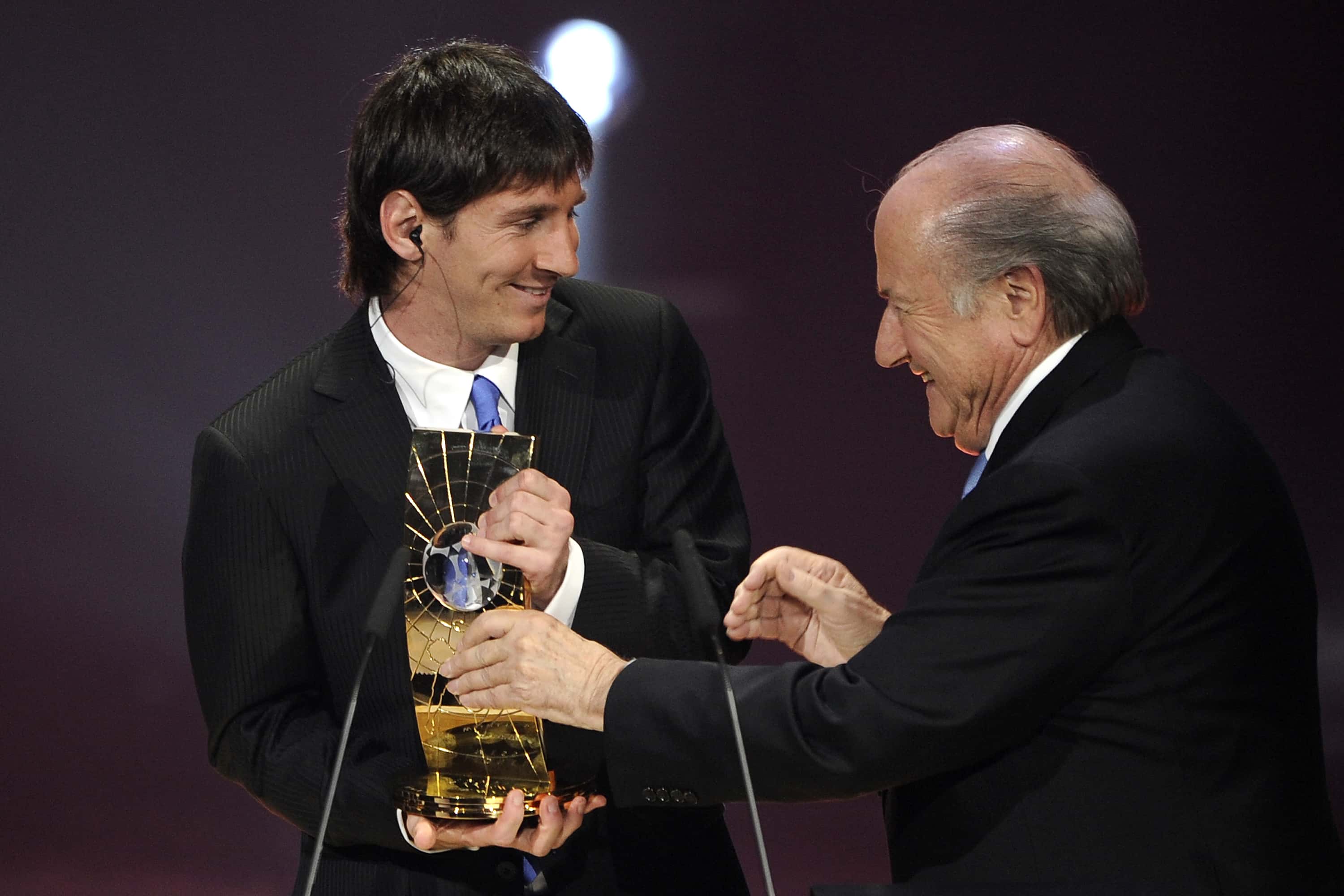  Lionel Messi receives the trophy from the hands of FIFA president 