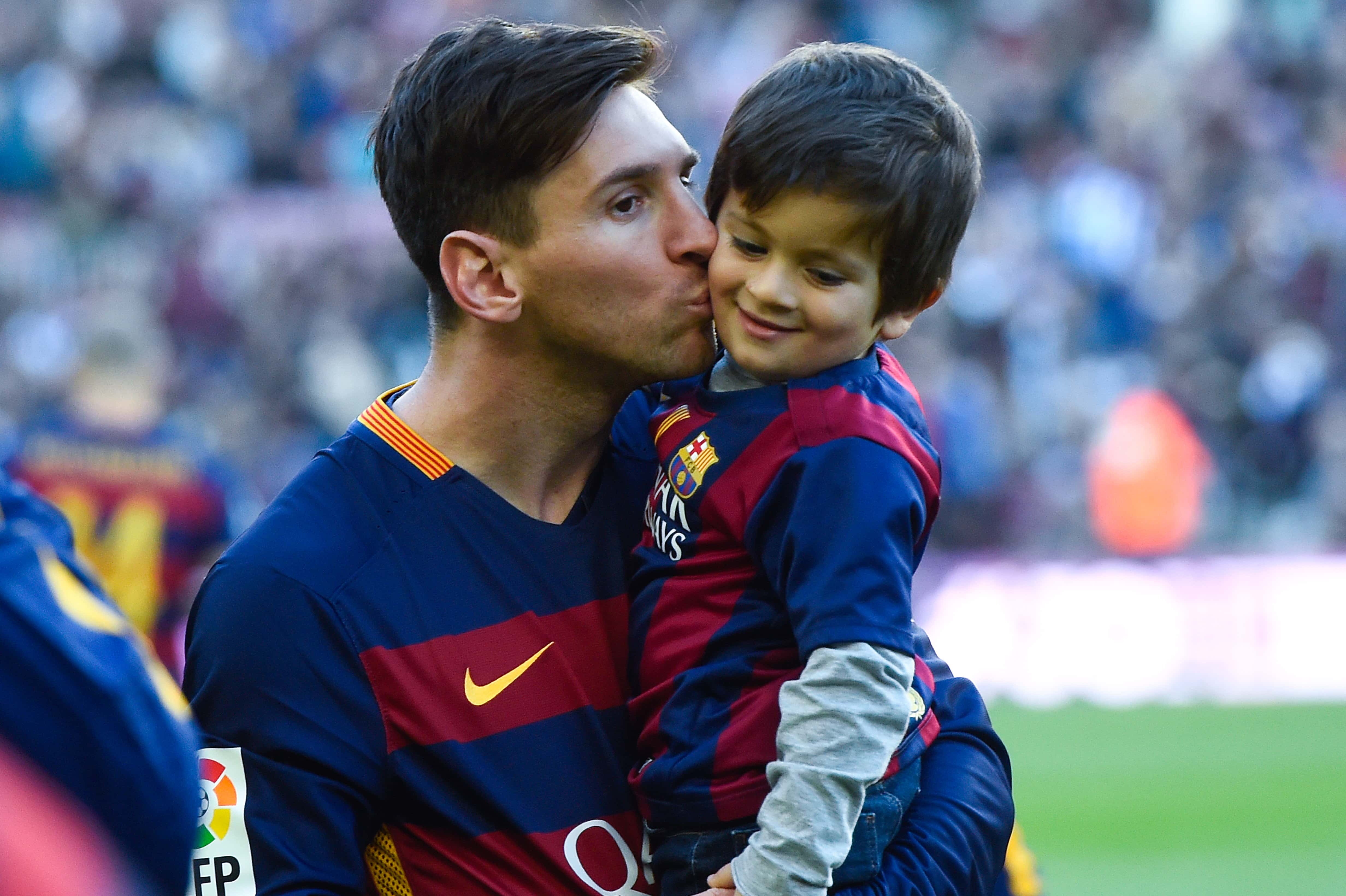 Lionel Messi of FC Barcelona kisses his son Thiago