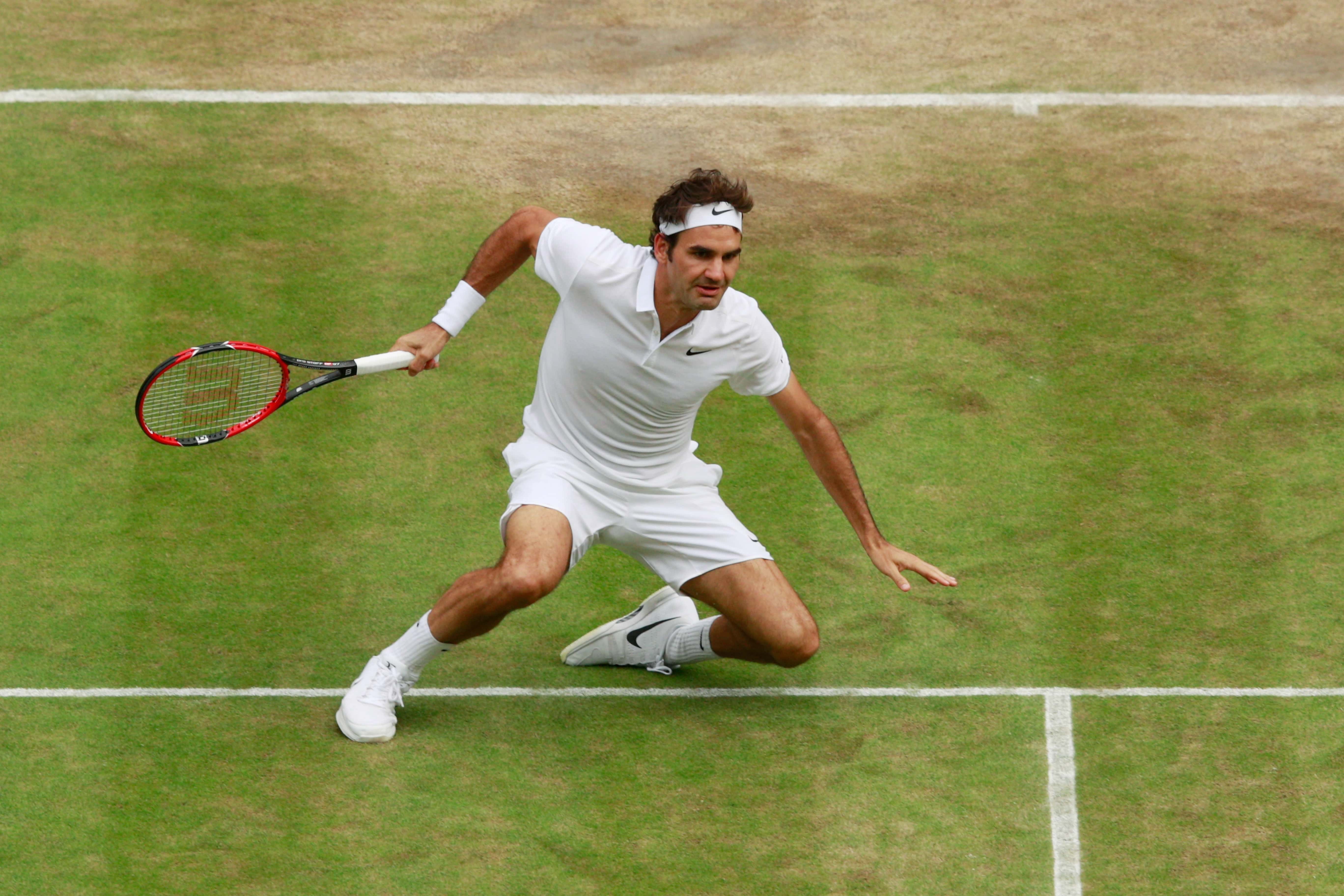 Roger Federer of Switzerland slips during match in Wimbledon 