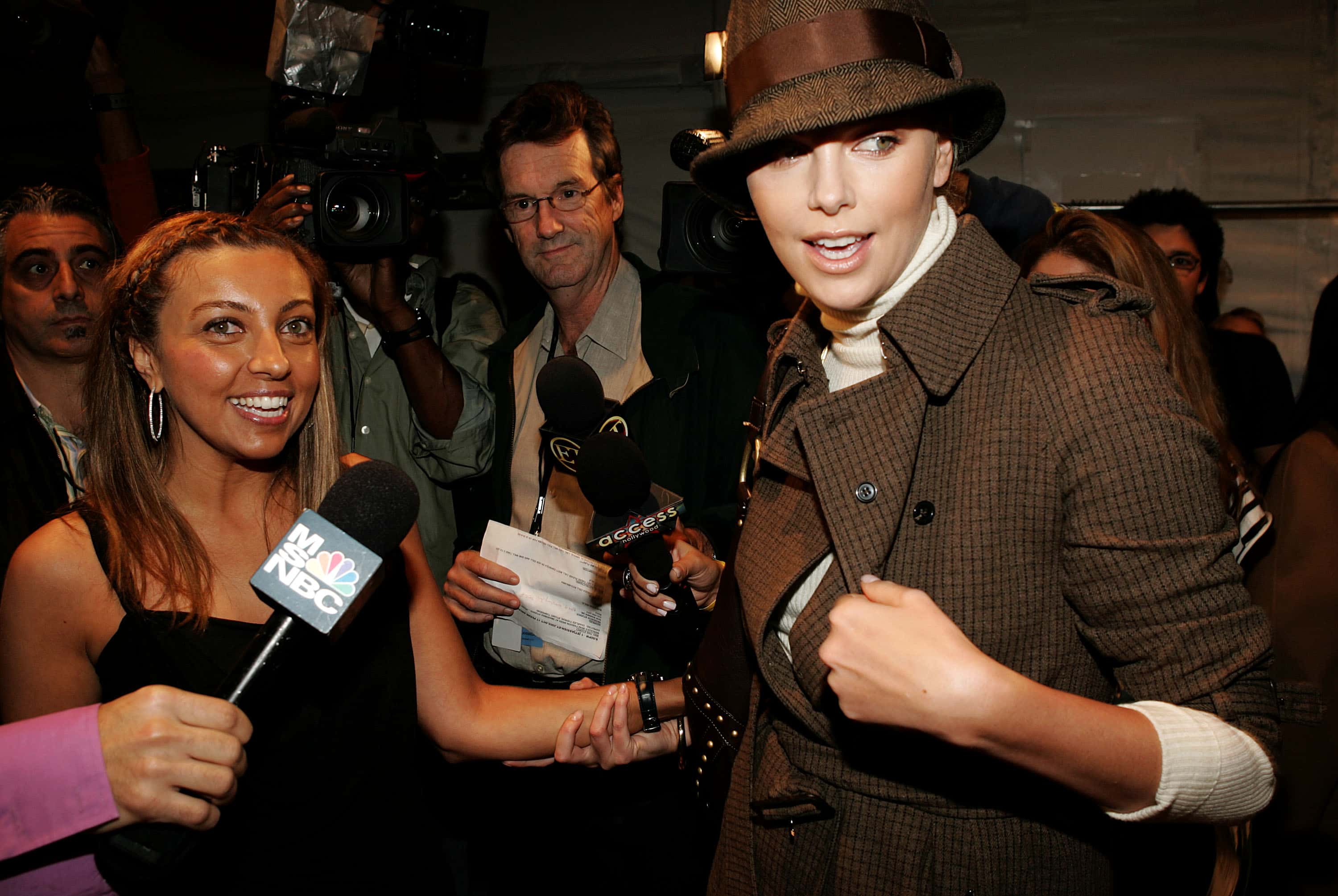 Pegah Anvarian (L) and Actress Charlize Theron talk backstage 