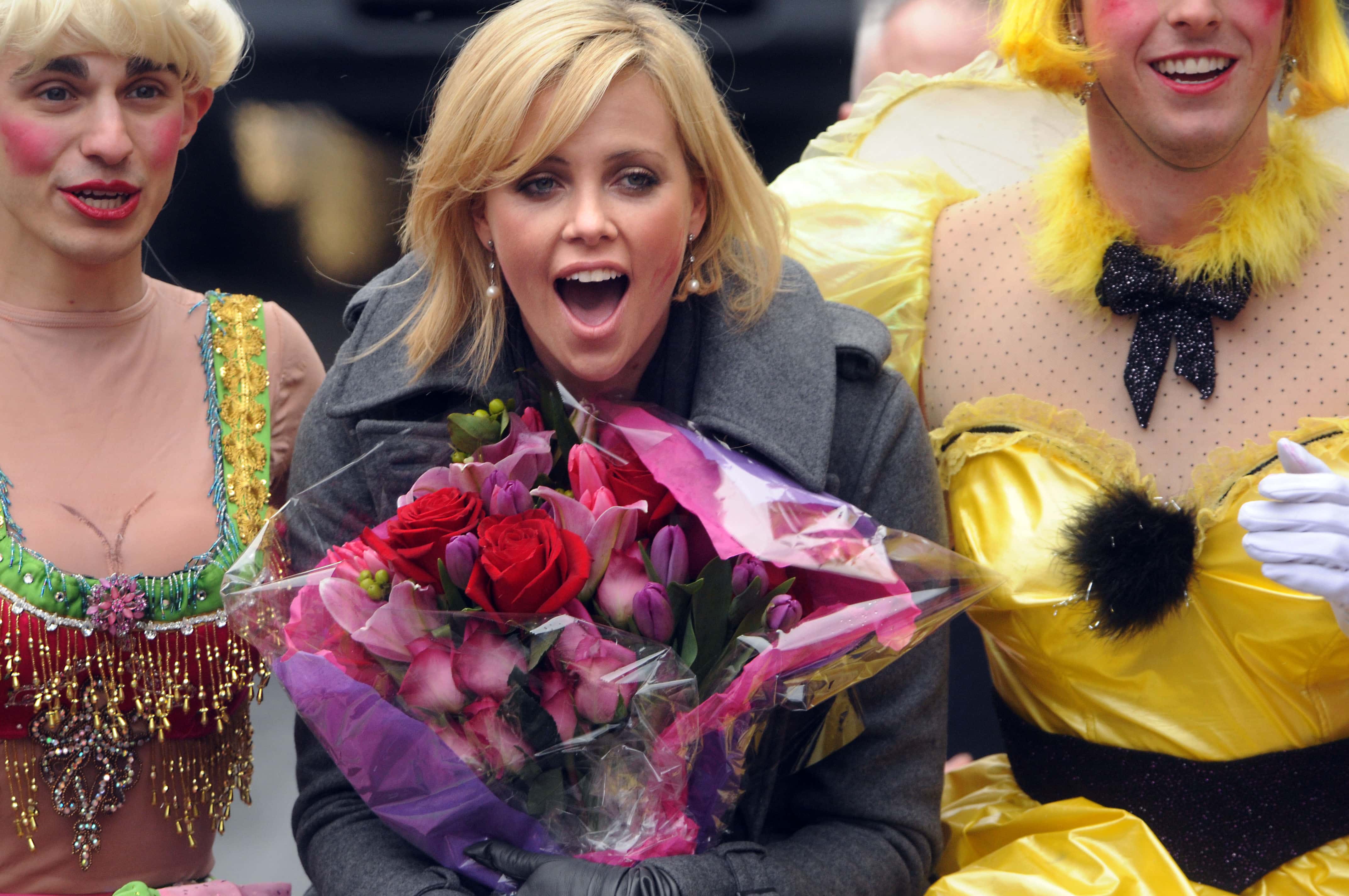 Charlize Theron is paraded through the street of Harvard Square