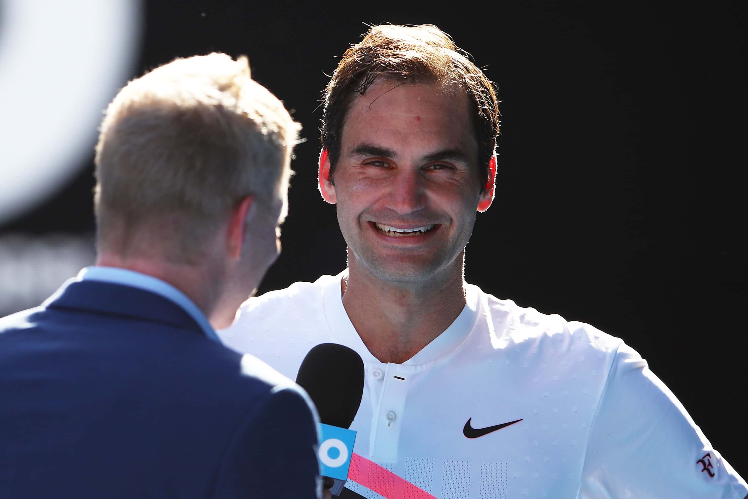 Former tennis player and commentator Jim Courier interviews Roger Federer