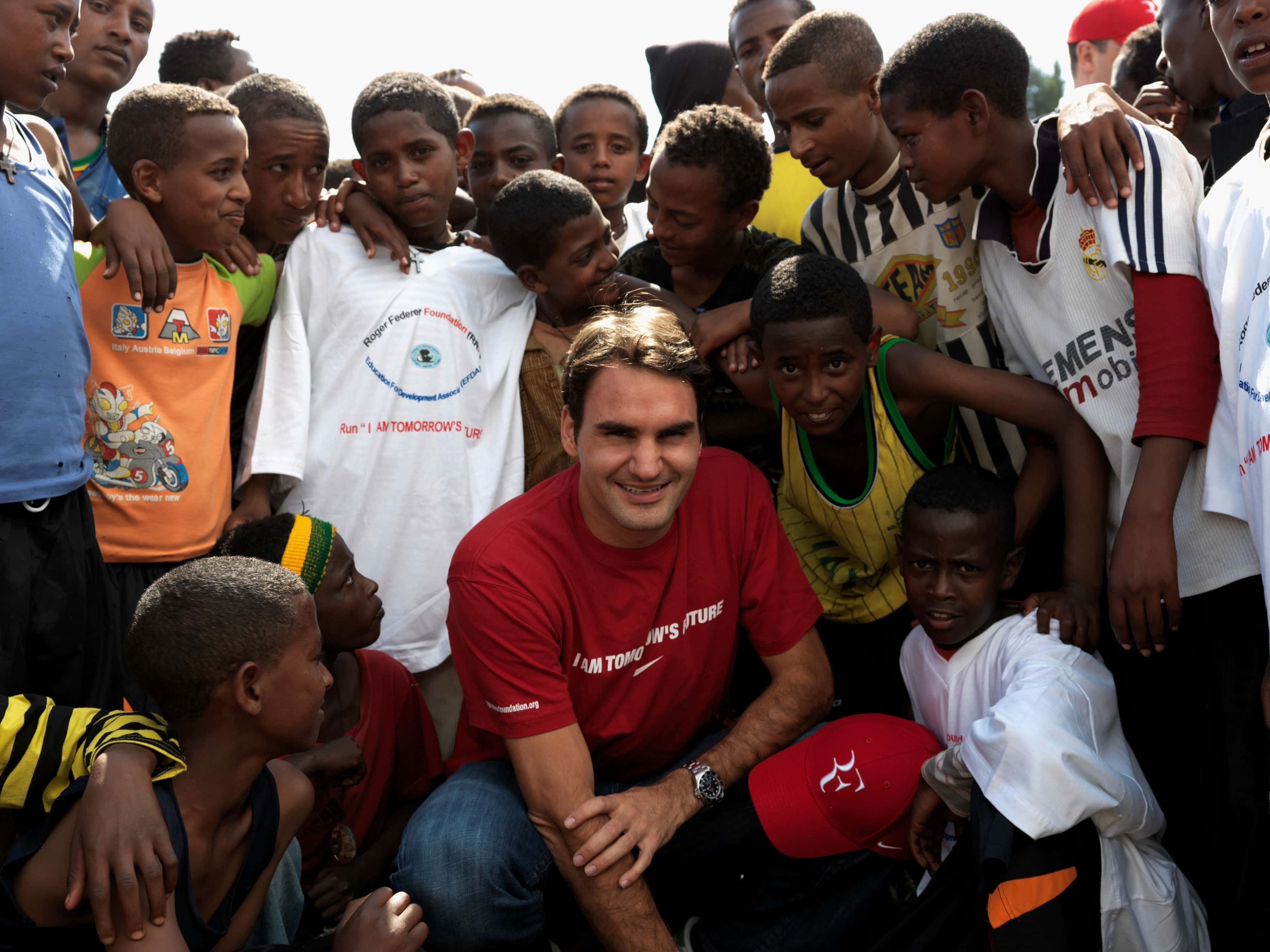 Roger Federer poses with local school children in Kore Roba, Ethiopia