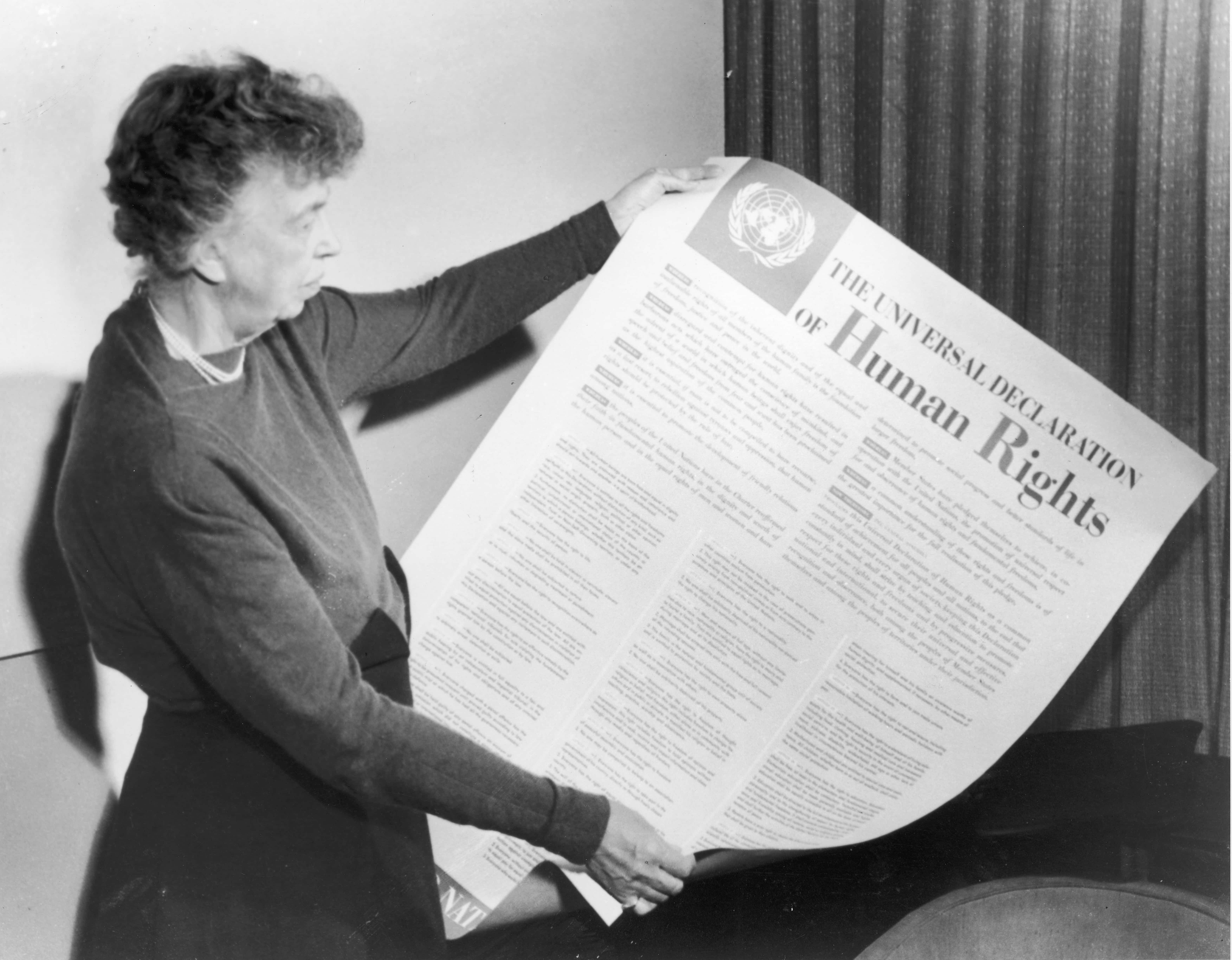 Eleanor Roosevelt holds up a copy of 'THE UNIVERSAL DECLARATION OF HUMAN RIGHTS', circa 1947