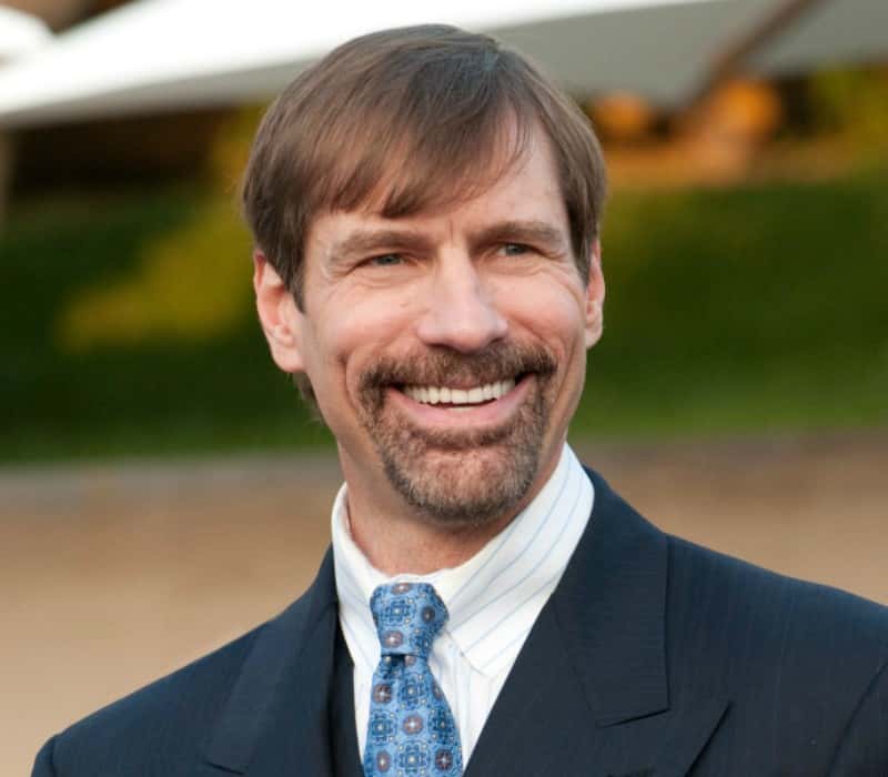 Henry Nicholas wearing a suit and tie