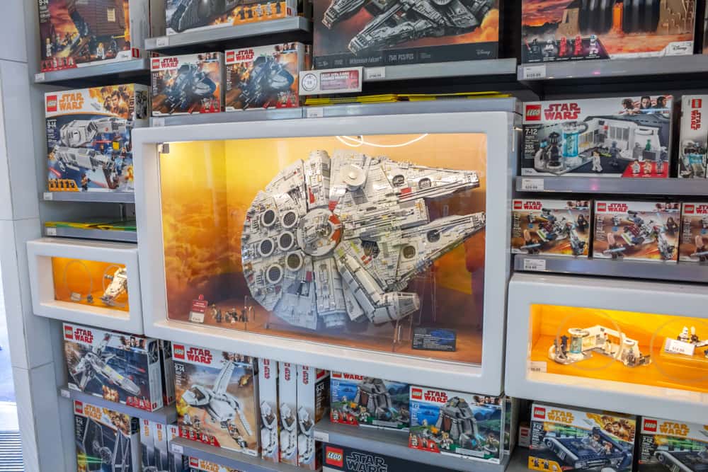 Model of the Star Wars Millennium Falcon in a glass display case at the Lego store