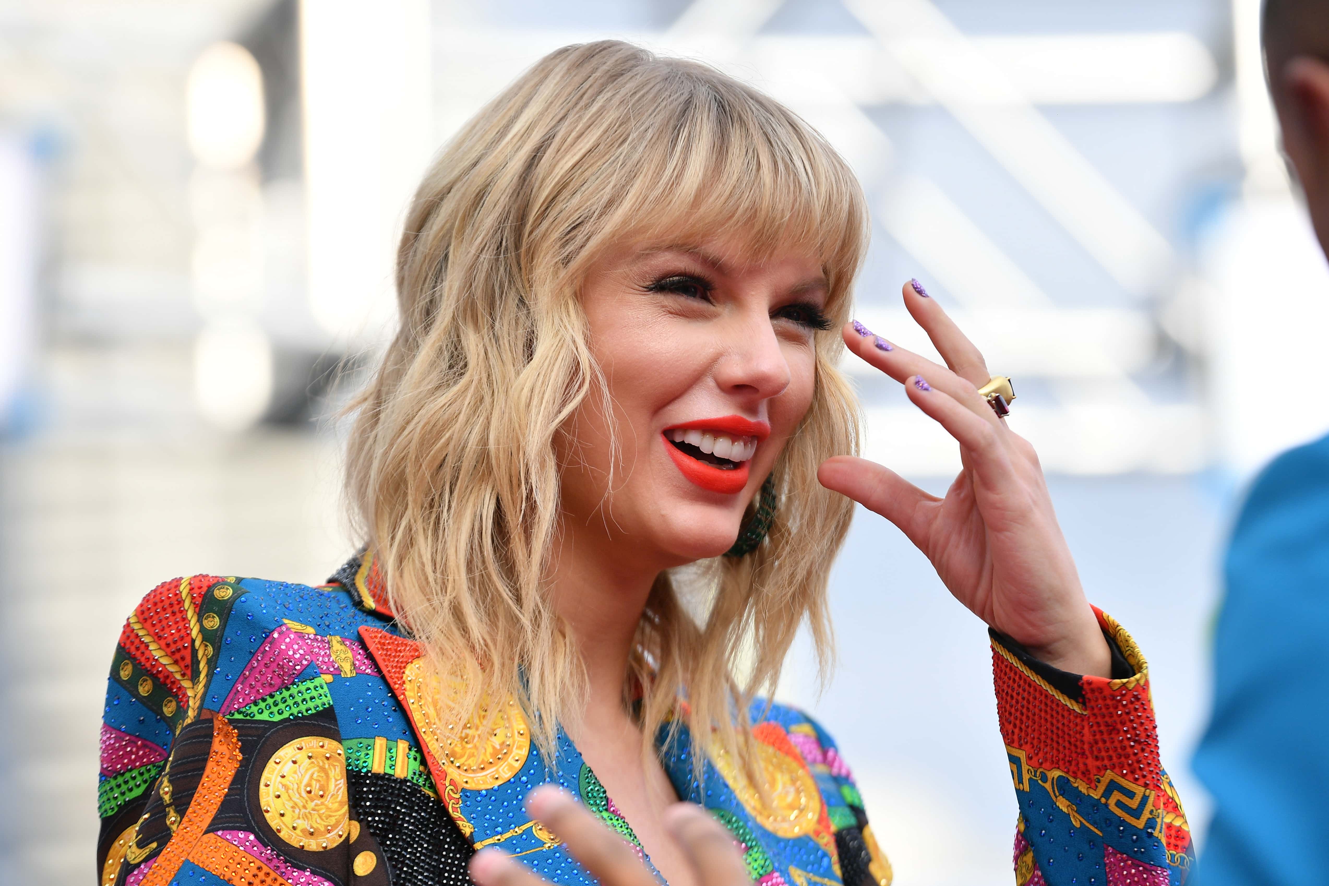Taylor Swift attends the MTV Video Music Awards at Prudential Center on August in Newark, New Jersey, wearing a vibrant outfit, smiling