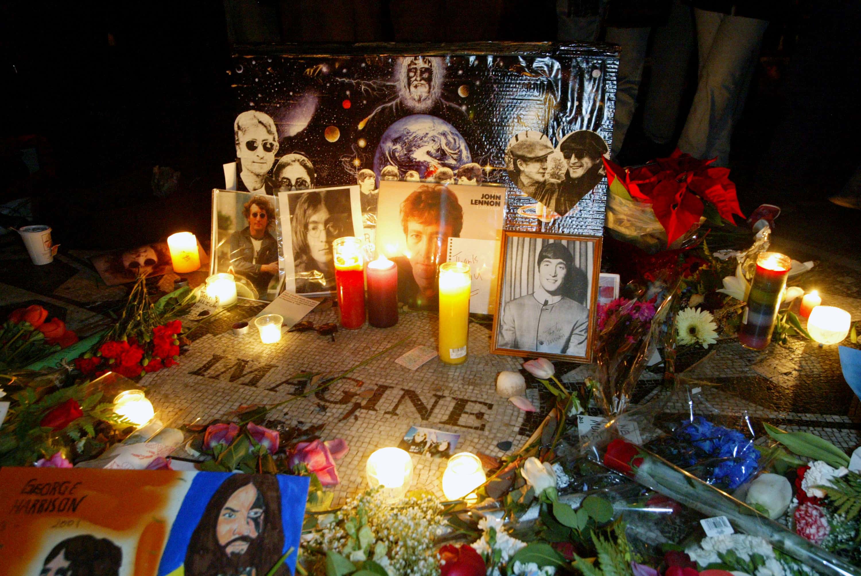 Fans mark the anniversary of musician John Lennon's death with a makeshift memorial at Strawberry Fields in Central Park