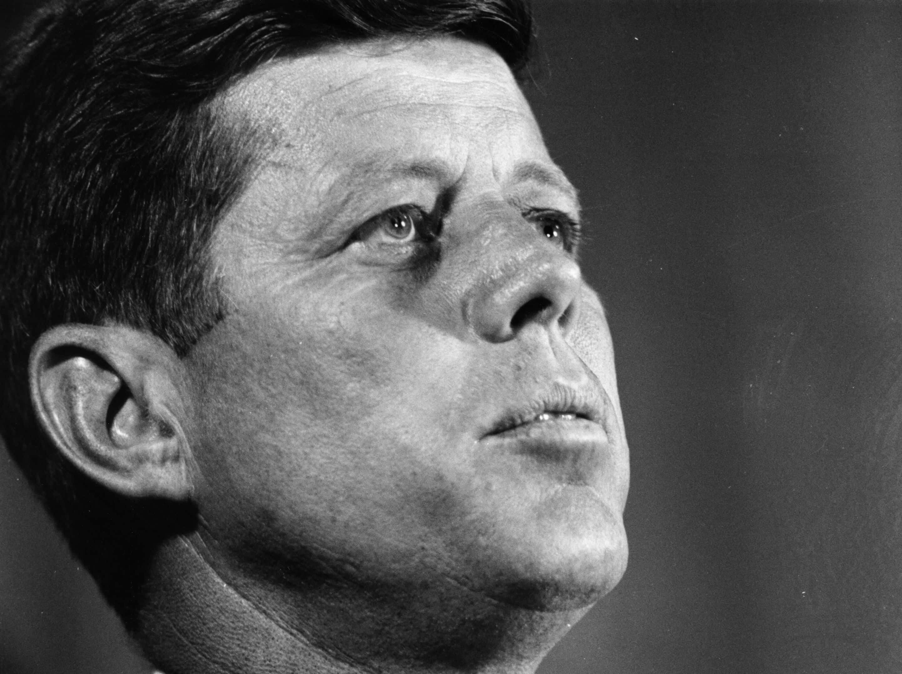 Grayscale Portrait Photo of John Fitzgerald Kennedy looking upwards