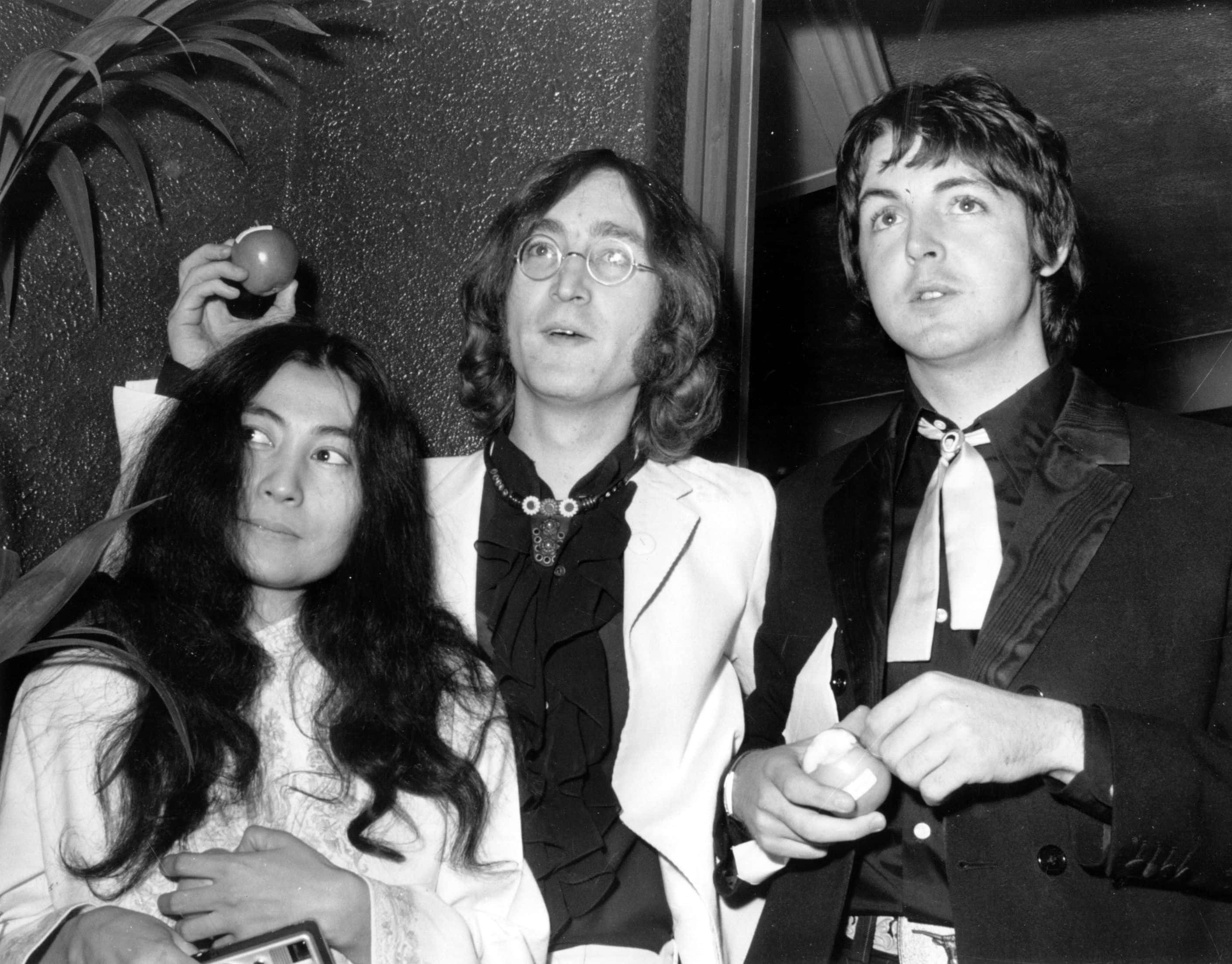 Beatle John Lennon (1940 - 1980) and his Japanese girlfriend Yoko Ono with Beatle Paul McCartney, right, at the premiere of the new Beatles film 'Yellow Submarine' at the London Pavilion.