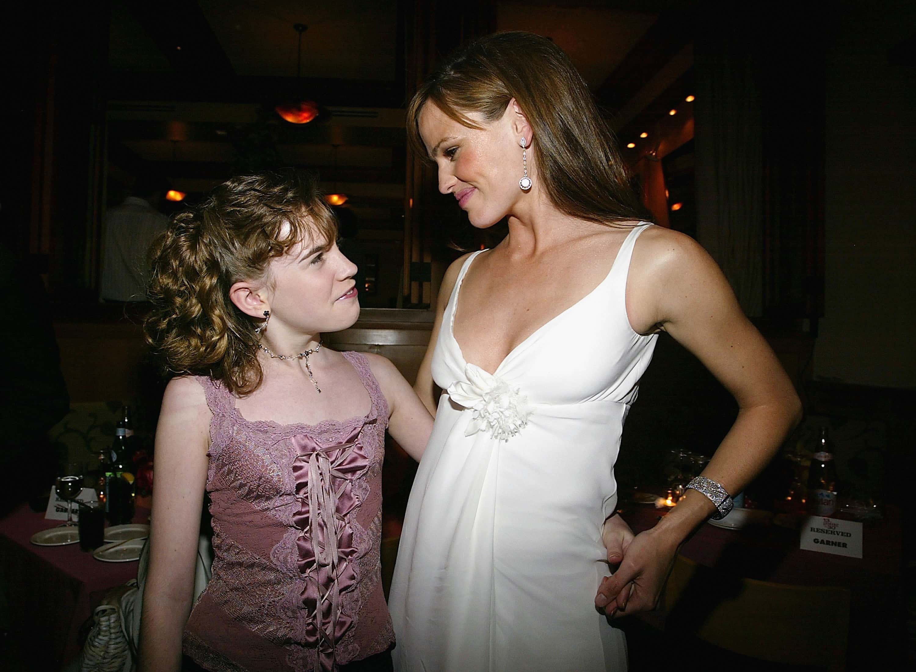 Christa Allen and actress Jennifer Garner hug at the after party for the film "13 going on 30"
