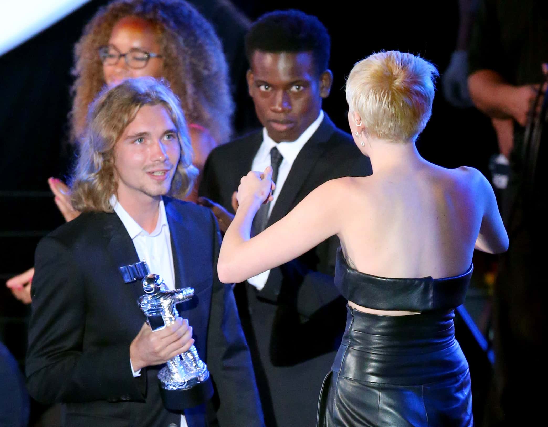 My Friend's Place representative Jesse Helt (L) accepts Video of the Year with singer Miley Cyrus