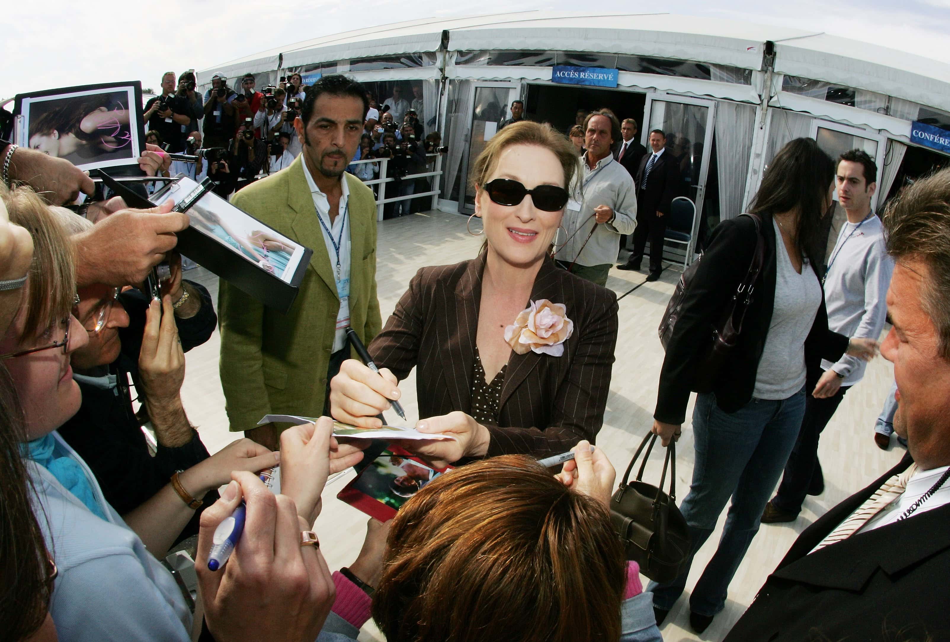 Meryl Streep  in green signing autographs