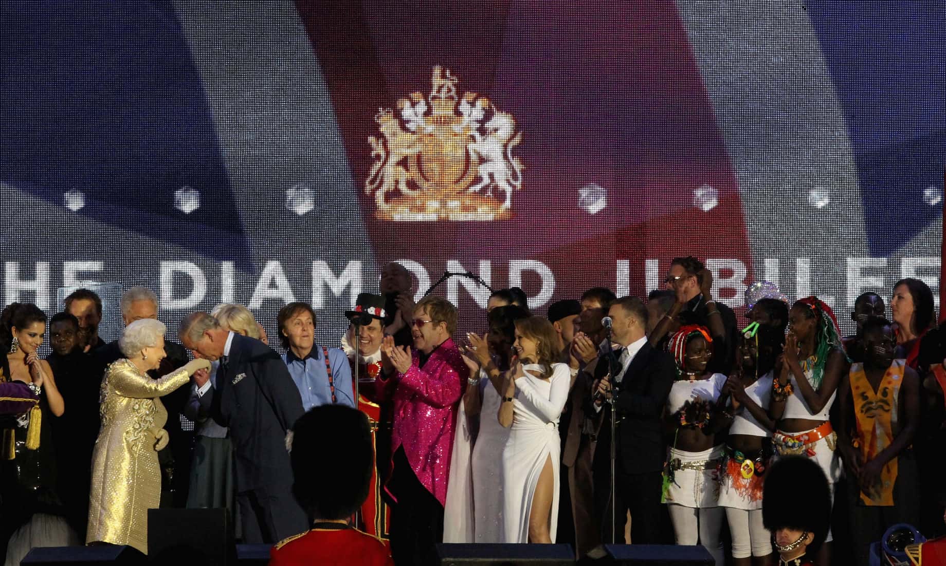 Queen Elizabeth II and The Prince of Wales (L) on stage with artists
