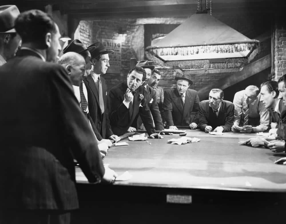 Mobsters meeting around pool table