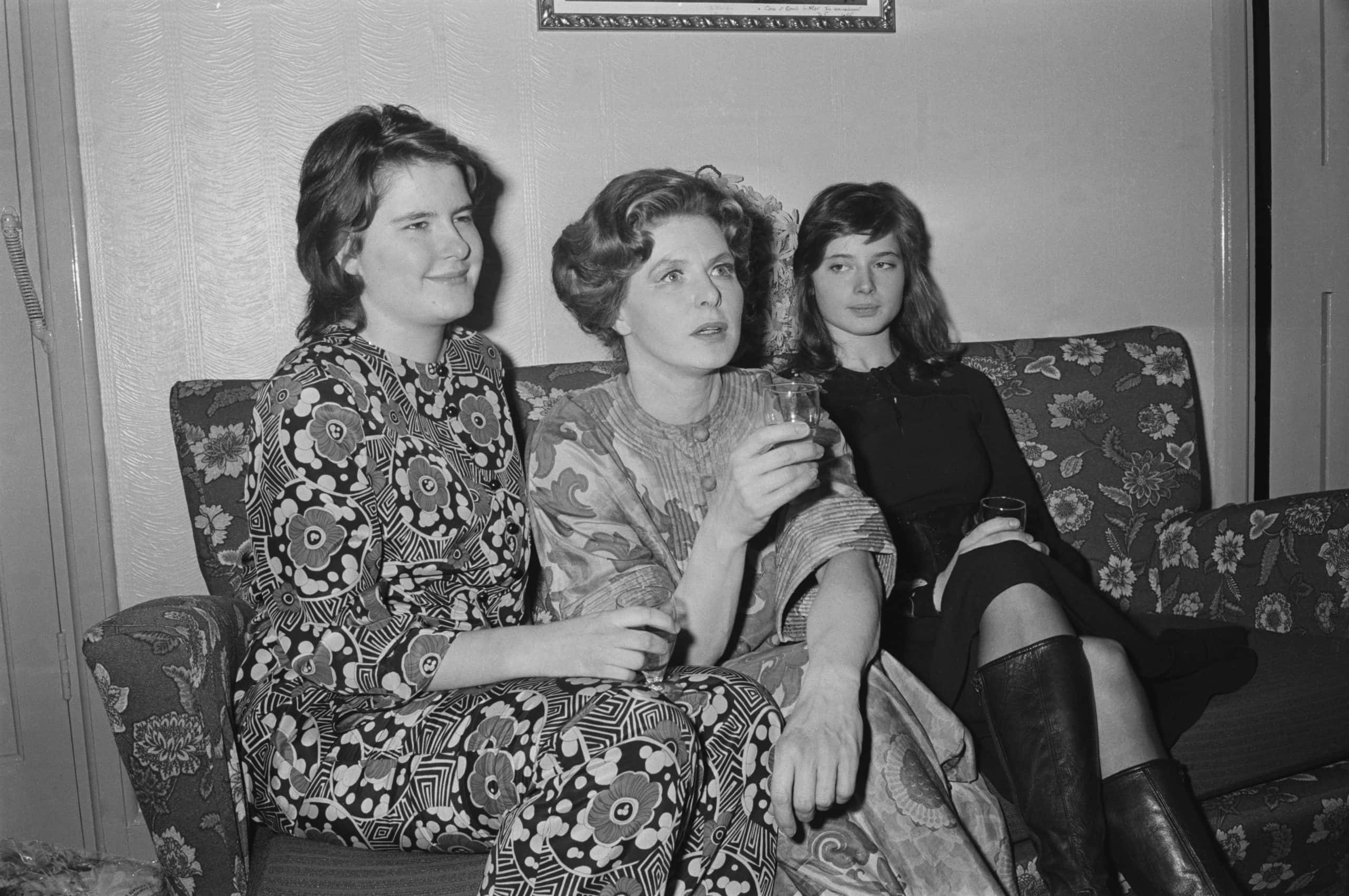 Ingrid Bergman And Daughters sitting on a couch