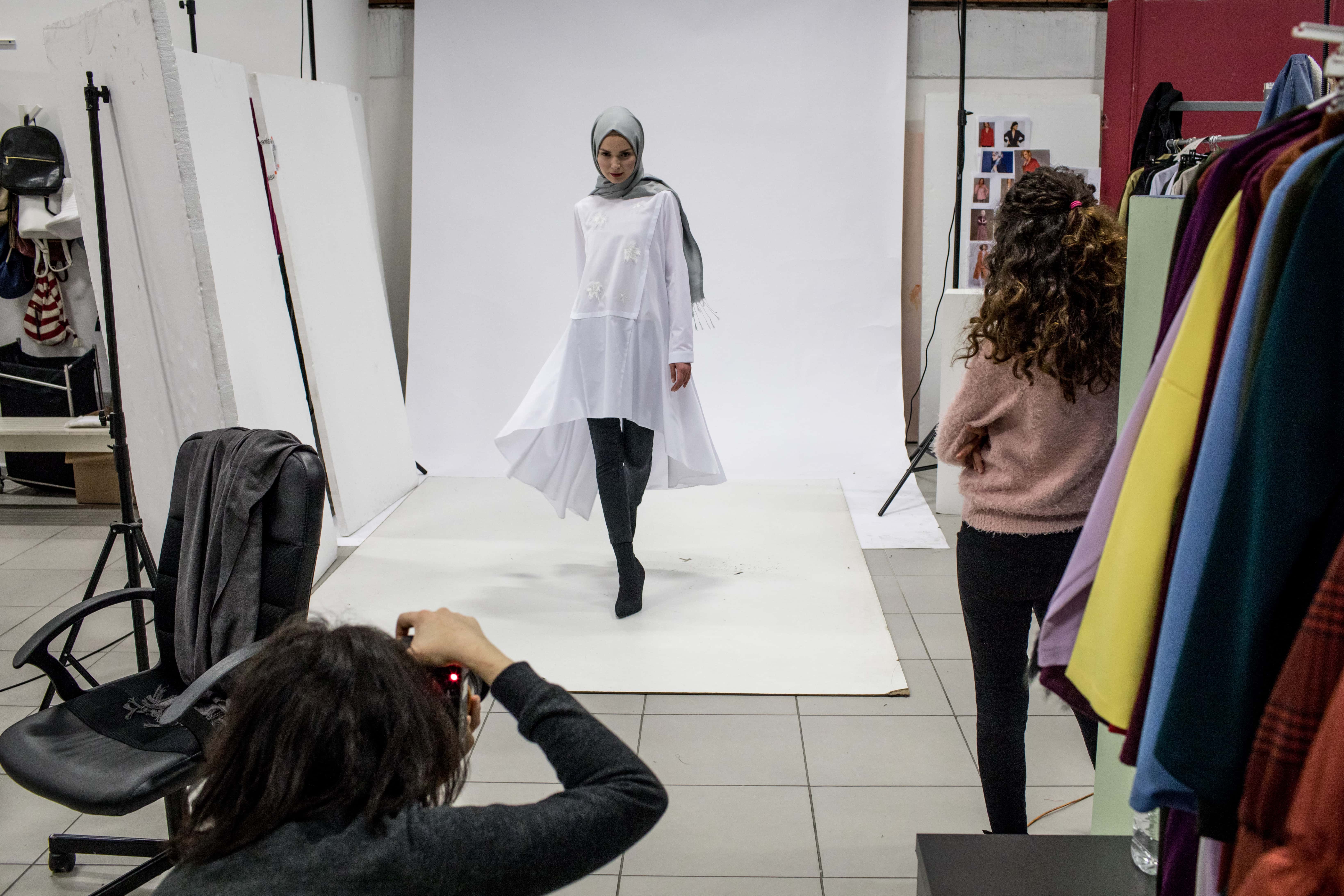 A model poses during a photo session for online modest clothing brand Modanisa