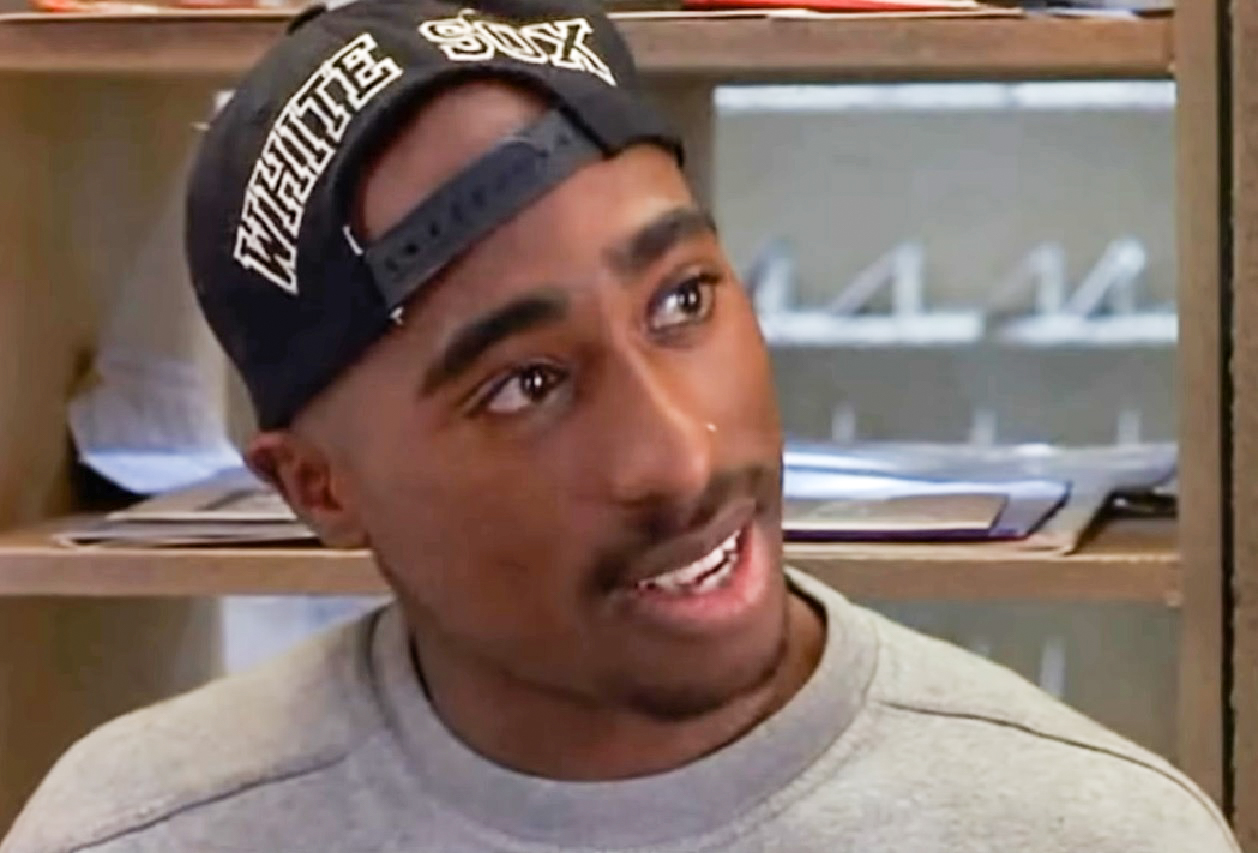 Screenshot of Tupac Shakur looking at side.