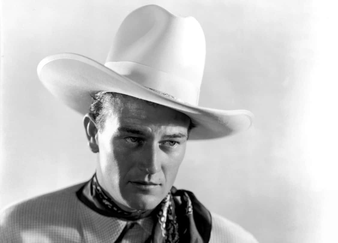 Portrait Photo of the actor John Wayne, wearing cowboy hat and cowboy outfit