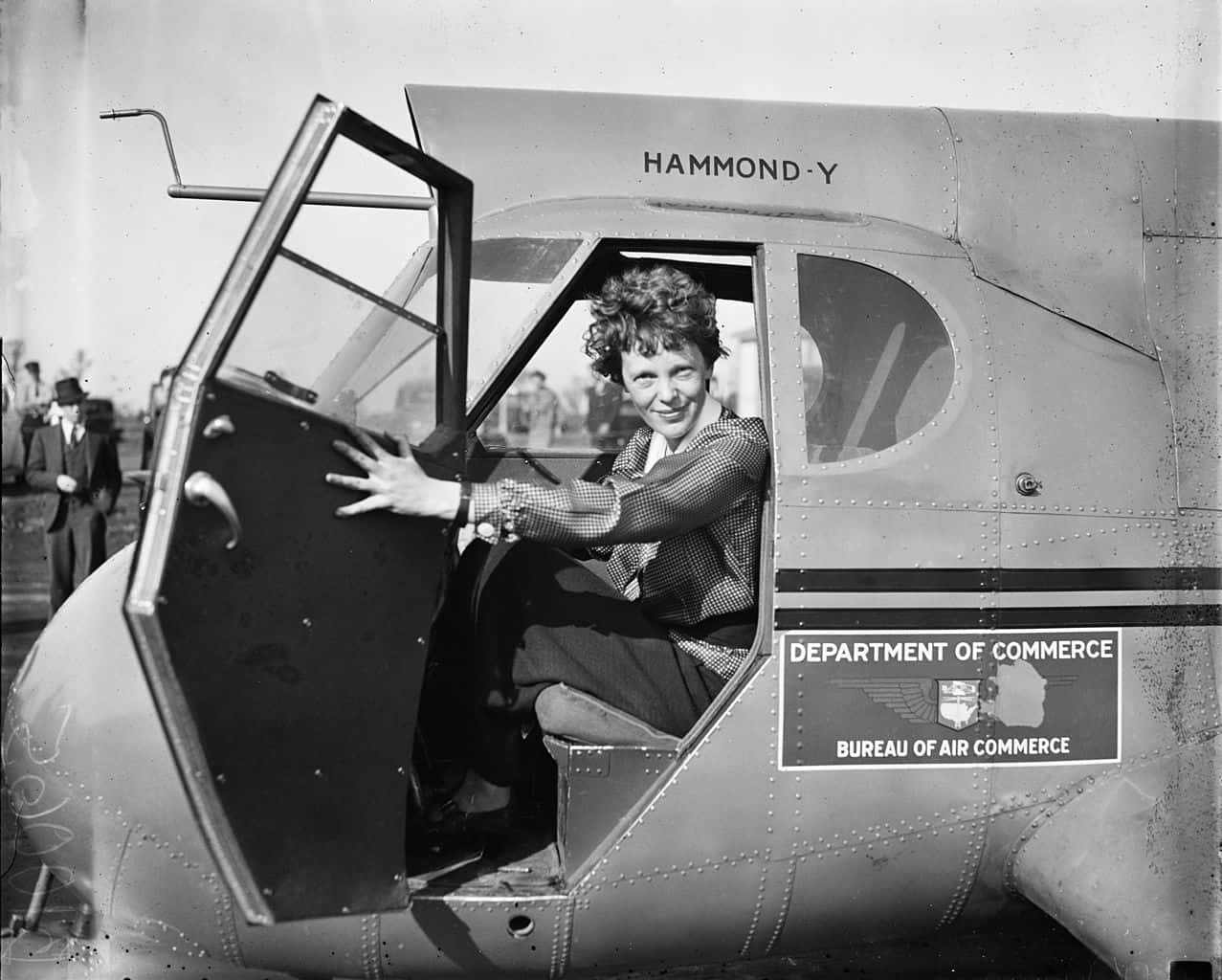 Amelia Earhart wearing a shirt  in the  airplane